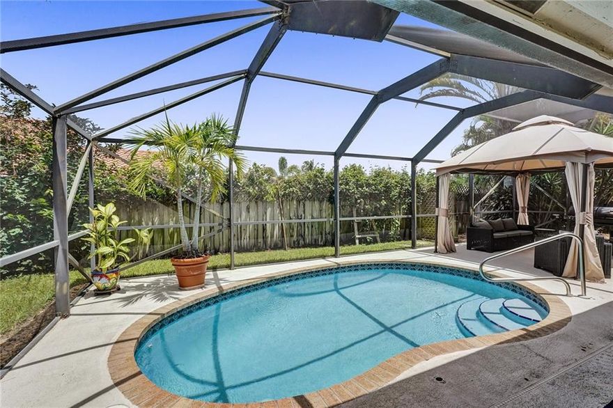 Your private Florida oasis awaits! This beautiful three bedroom, two bath pool home is designed to accentuate the gazebo and pool area and a lush garden area with many varieties of tropical trees and plants. This home has beautiful wood floors, vaulted ceilings, and pool views from an open kitchen and a large living/family room. Enjoy natural light in a fabulous glass-walled sunroom. Upgrades include new HVAC, dishwasher, washer, drier. Features include a remodeled bathroom, hurricane sliding glass doors, inside storage and two sheds, and a pool enclosure over the pool and gazebo area. It's a short walk to the lakeside park and playground, private tennis courts, and a pavilion that can be reserved for parties, all for a low HOA fee! A private, lush, very personal oasis! Come and see!!