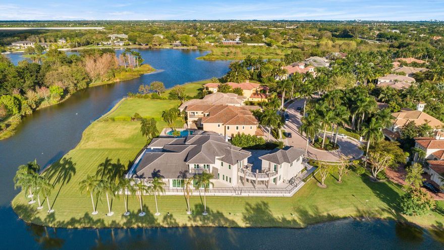 Rare opportunity in the prestigious, gated community of Le Rivage in Boca Raton. Set at the end of a private cul-de-sac, this 7-bedroom modern estate offers over 7,800 sq ft of living space on an oversized lakefront lot of more than half an acre, with water views wrapping around two sides of the home.  The main level features an open-concept layout with soaring LED backlit ceilings, a chef's kitchen with Thermador and Miele appliances, custom cabinetry, quartz countertops, large island, and breakfast area. The great room's floor-to-ceiling pocket sliding doors showcase stunning lake and pool views, while a walk-in wet bar with wine refrigerator and formal dining room create an ideal entertaining setting. Also on the main level is a guest bedroom and an impressive primary suite with sitting area, dual spa-style baths, two custom walk-in closets, and a private office/TV room.  Upstairs offers three en-suite bedrooms, a spacious loft with built-ins, and balcony access. A covered walkway leads to a 2-bedroom, 2-bath guest house above the garage. The air-conditioned, lift-ready 3-car garage is accessed separately via a covered walkway.  Outdoor living features a resort-style pool with sun shelf and spa, expansive patio, full summer kitchen, and lush tropical landscaping overlooking the lake. Additional highlights include a whole-house generator, water filtration system, Crestron smart-home automation, and dedicated AV/mechanical room.