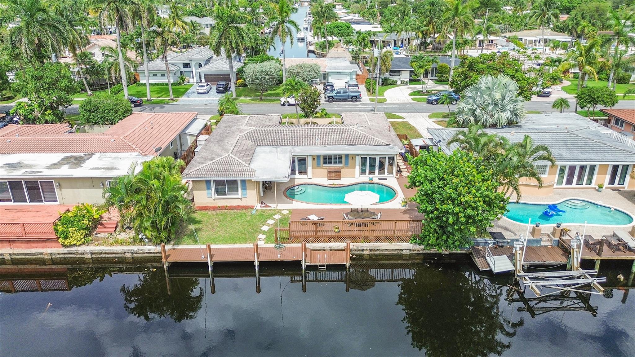 Best-priced ocean access waterfront pool home in Pompano Beach! Located in sought-after Cypress Harbor, this 3BR/3BA home features a split floorplan, updated kitchen, renovated baths, full hurricane protection, garage, and a separate office or guest space. Bright and spacious interior with large windows and water views throughout. Primary bedroom overlooks the water. Interior waterline piping replaced in 2022. Tile flooring, stainless steel appliances, interior laundry, and circular driveway. New A/C system and ducts (2024), water heater (2024). Quiet cul-de-sac with entry courtyard that can be enclosed. East facing backyard. —great layout, sq footage and value! No hoa