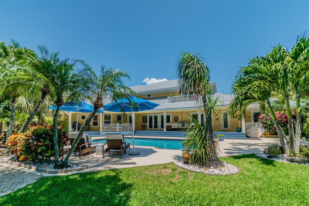 Nestled in the heart of Sewalls Point, is this gorgeous remodeled home from top to bottom. It even has a back entrance to a private cul de sac! Cook in your new chef's kitchen with granite countertops, ss appliances, and new custom light fixtures. Lvg room boasts oak wood floors, custom built-in cabinets, & open floor plan. French doors lead to fenced, outdoor entertainment w saltwater pool & spa. Completely remodeled master suite, 2 custom walk-in closets, new spa-like mstr bath w floating dual sink vanity, free standing soak tub & new elegant light fixtures. Spacious en-suite guest bedrooms, 3 zone A/C, whole house generator, impact windows, plantation shutters, cabana, fresh paint, metal roof, new carpet + a MULTITUDE more of amenities! This is your paradise home!