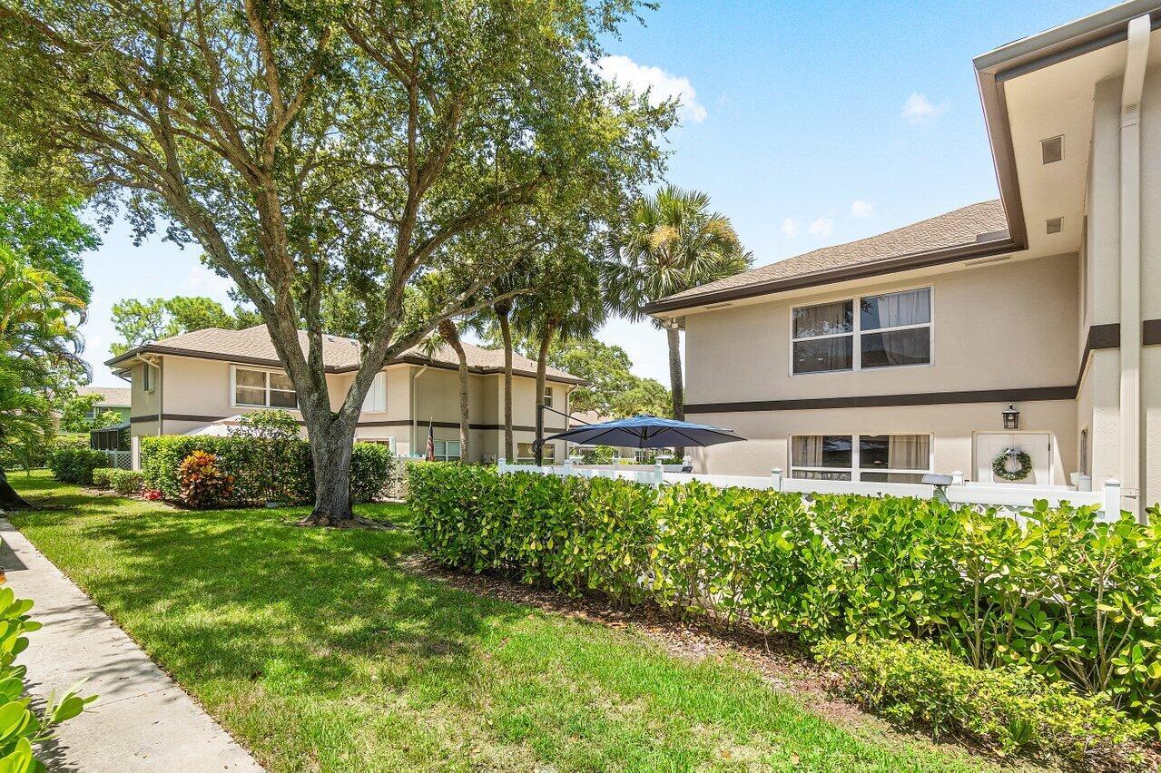 Welcome home to this beautifully updated 2-bedroom, 2.5-bathroom quad-style townhouse, 2023 roof that combines comfort, style, and privacy in one perfect package. Nestled among mature shade trees, this picturesque home offers a serene escape from the hustle and bustle of everyday life.Step inside to find a bright and airy interior featuring new flooring throughout and a spacious, open-concept family room filled with natural light. The beautifully renovated kitchen is a true highlight, boasting ample storage, a convenient lazy Susan, and sleek finishes that make cooking and entertaining a breeze. Upstairs, you'll find two generously sized bedrooms with refreshed bathrooms, offering both comfort and style. Outside, a fully fenced private courtyard provides the perfect setting for