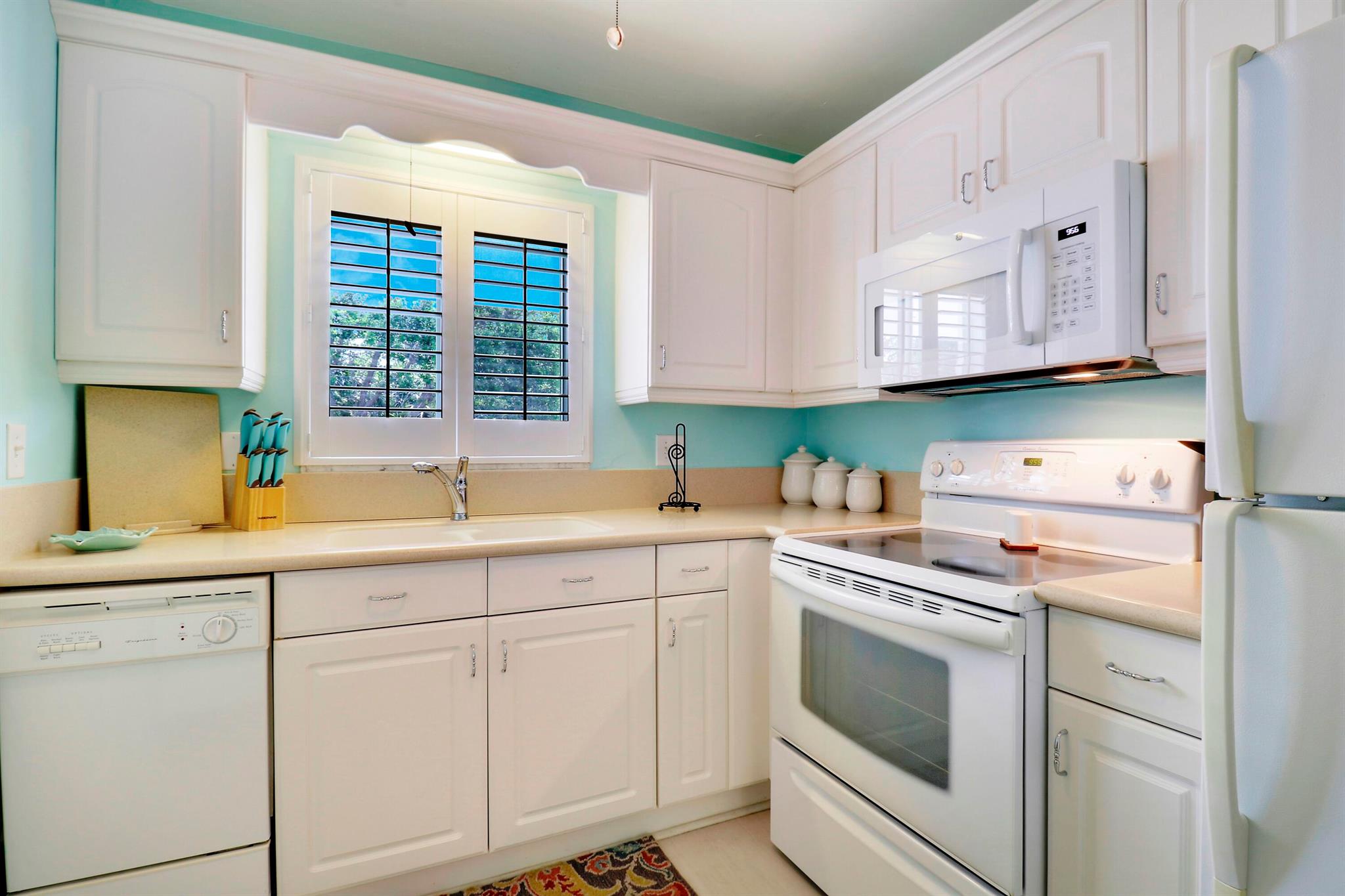Furnished/Turnkey 55+ condo in the FABULOUS Village of Tequesta where there's always something going on. Enjoy the comfort and security of this updated 2nd floor 2 bd 2 ba END unit. Relax in extended 1072 sf Living area U/A with floor to clg sliders looking out to a lovely green area. New Vinyl plank flooring in living, dining & kitchen. Newer AC & Wtr Htr. W/D combo in the unit. Hurricane impact windows/sliders. Easy access to assigned parking space. Primary has walk-in closet. Community offers 2 swimming pools, shuffle board, putting green, clubhouse with billiards & social activities. Complex is NOT effected by 3 story structural reserve. Buildings are 2 storiesClose to beautiful beaches, fishing, restaurants, shopping, golf, tennis & more. PBI is <30 minutes away