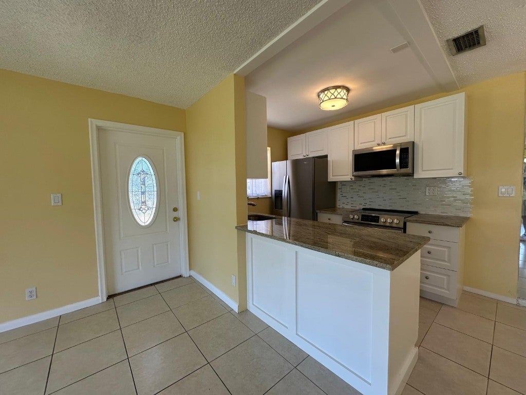Photo of 665 High Point Drive, Delray Beach, FL 33445 (MLS # F10516234)