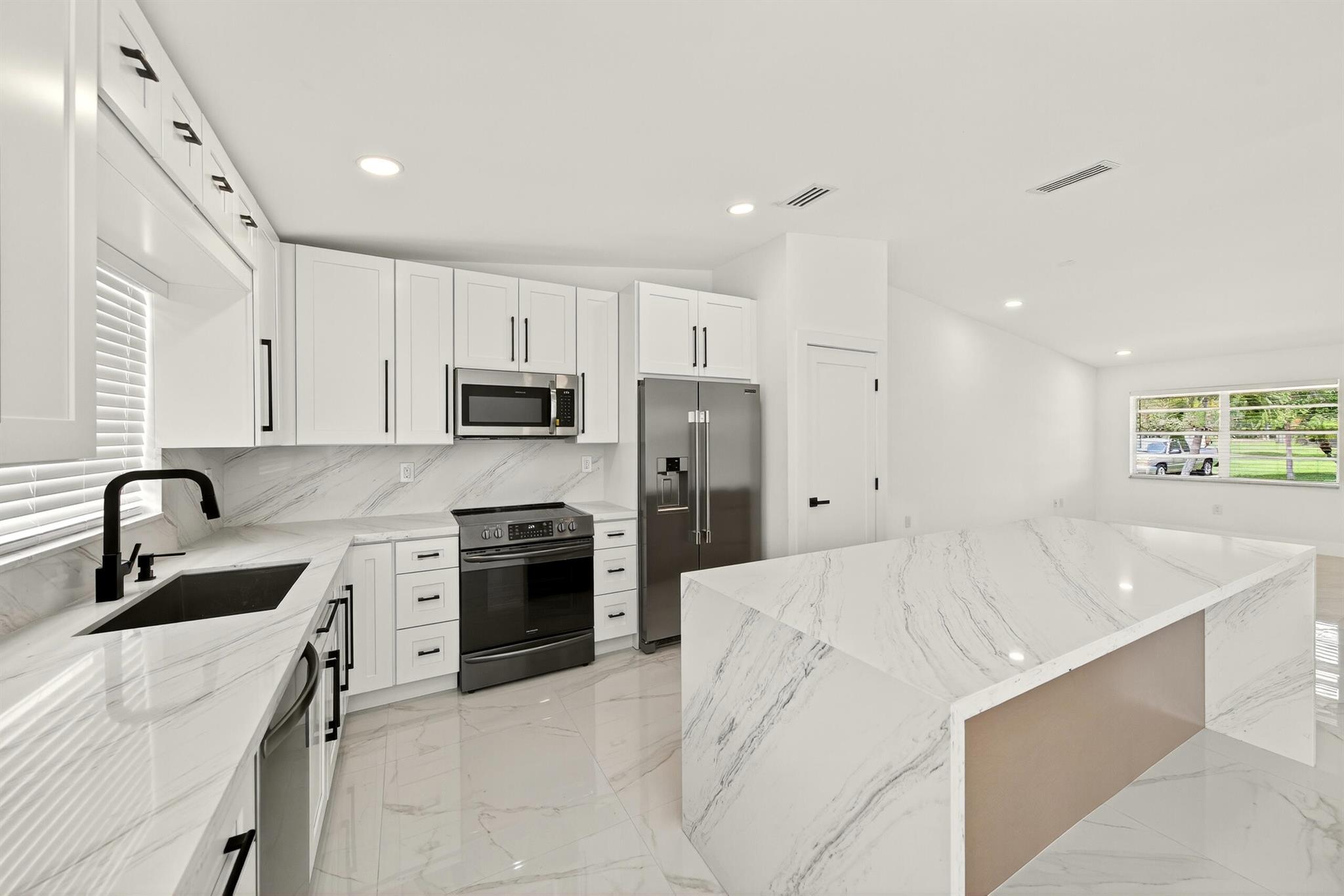 This fully remodeled home blends modern elegance with peace of mind. Showcasing 40''x40'' imported Spanish porcelain tile, Calacatta Gold countertops, and a chef-inspired kitchen with stainless steel appliances. Every appliance-from kitchen to laundry-is BRAND NEW, as well as the CENTRAL A/C and TANKLESS WATER HEATER for energy-efficient comfort. PLUMBING and ELECTRICAL systems also been updated. The spacious patio is perfect for entertaining. Located in a pet-friendly community with low HOA ($100/mo), A+ rated schools, and easy access to 595, I-75, Turnpike. Enjoy a private park with a playground, dog park, heated pool, tennis, basketball courts, scenic trails, and a fitness center. Every detail-from flooring to fixtures-has been elevated for a turnkey lifestyle of luxury and convenience