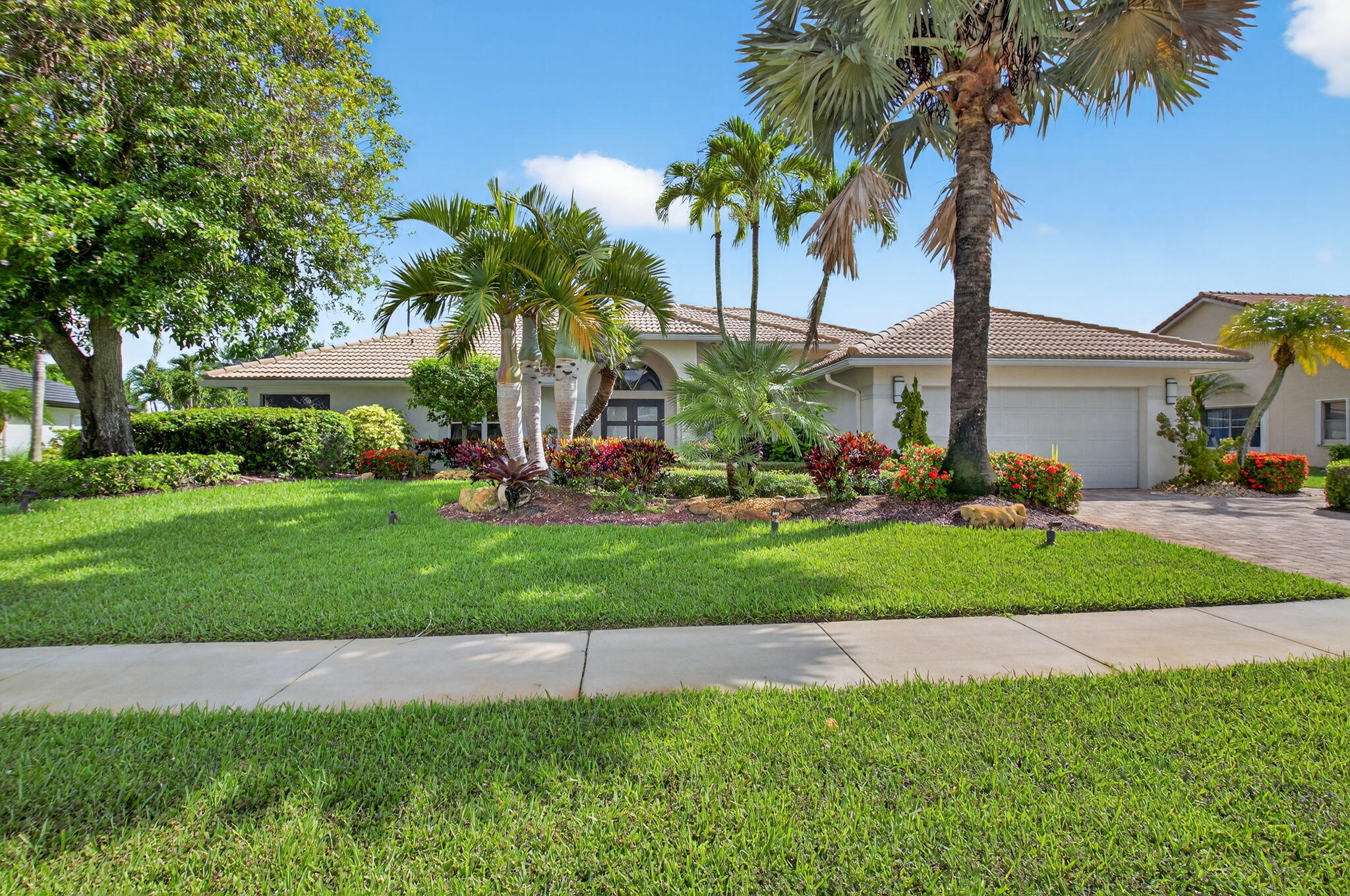 Welcome to 10791 River Glenn Dr, a stunning single-family home in the heart of Boca Woods Country Club.This residence offers a spacious 2,726 square feet of elegantly designed living space, featuring three bedrooms and two and a half bathrooms, perfect for comfortable family living. Upon entering, you'll be captivated by the home's southern exposure which bathes the interiors in natural light through stylish casement windows. The living areas are adorned with a blend of carpet and ceramic flooring, enhanced by modern recessed lighting that creates an inviting ambiance throughout.The gourmet kitchen is a chef's dream, equipped with stainless steel appliances including a cooktop, double oven, refrigerator, and dishwasher. The eat-in kitchen area provides a relaxed dining space