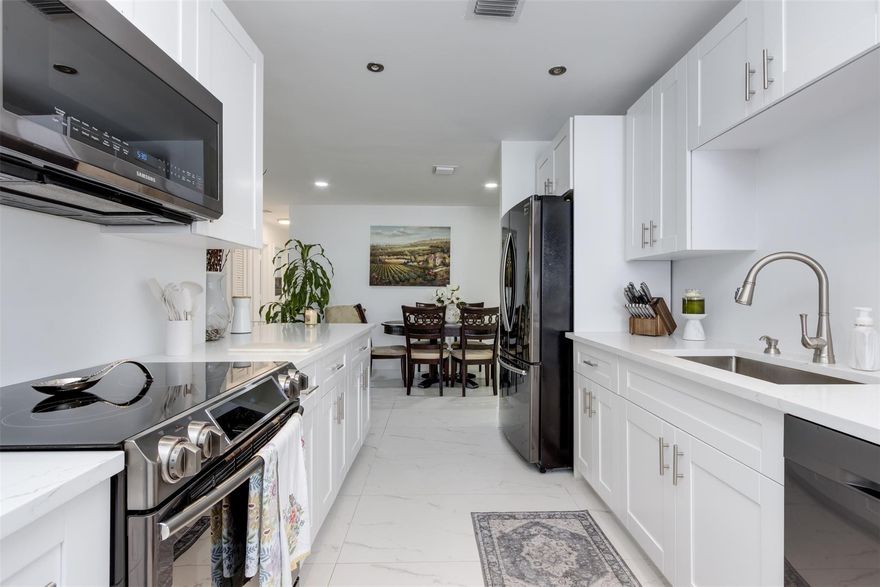 Welcome to this beautiful 3-bedroom, 2-bathroom Single Family home in Tamarac Lakes South. The gorgeous renovated kitchen, completed in 2025, features quartz countertops, black stainless steel appliances, and bright white cabinetry. This desirable floor plan includes two full bathrooms and a covered carport that provides convenient additional parking, a rare find in the community. Recent upgrades include a 2021 aluminum roof, 2023 AC, and tile flooring throughout. The private backyard has an awning for shaded outdoor enjoyment plus a variety of fruit trees. Low monthly HOA dues cover lawn care, sprinklers, community pool, clubhouse, golf, and exterior paint every 2 to 4 years, most recently in 2024.  Pets are welcome, up to 3 per household.