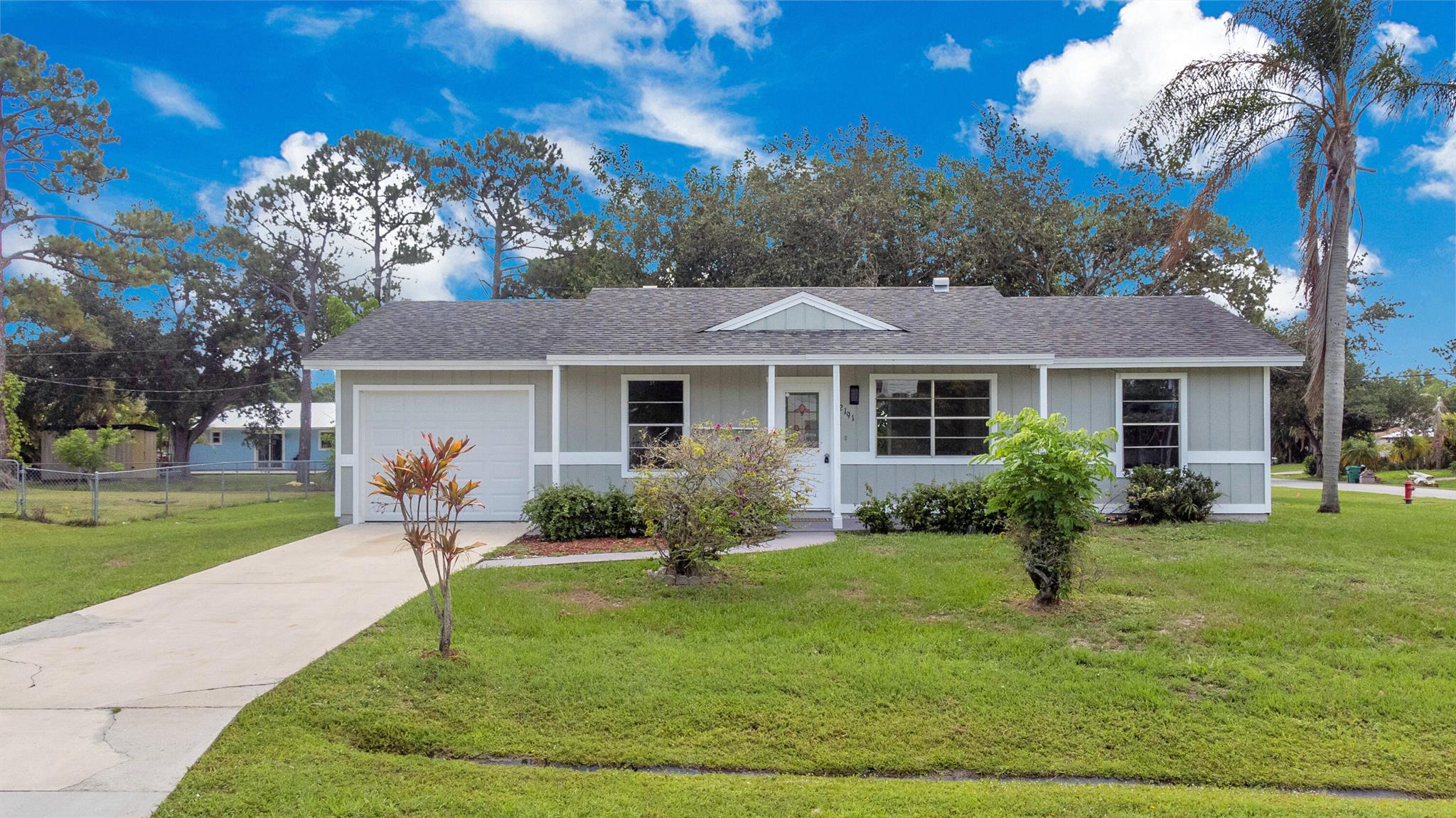 This home offers easy access to top-rated schools, community parks, shopping centers, and healthcare facilities, all within a few mins. Perfect for families and those seeking convenience in Port Saint Lucie! Updated 2BD/2BA on Oversized Corner Lot. Freshly painted inside & out with remodeled bathrooms, new fixtures, and stainless steel appliances. Features include a 1-car garage with washer/dryer + large yard, and storage shed. Move-in ready.