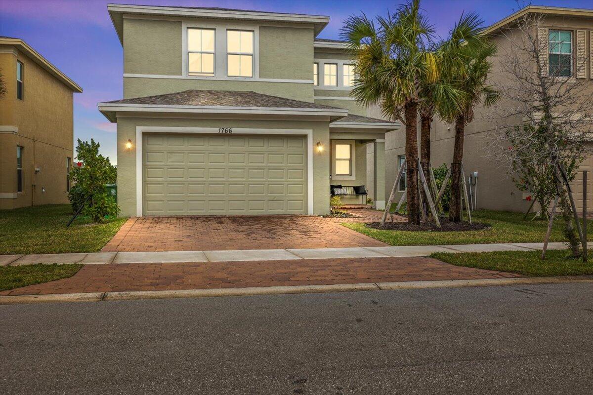Located in a charming Port St. Lucie neighborhood, this exquisite Kolter Homes property, built in 2022, showcases the rare Bianco Collection floor plan. It features three spacious bedrooms and a flexible office space that can easily transform into a fourth bedroom. The open-concept living area is highlighted by high ceilings and large windows, while the kitchen offers stainless steel appliances, granite countertops, and a sizable island. The master suite boasts a luxurious en-suite bathroom with a walk-in shower. The beautifully landscaped yard and covered patio, which offers a serene lake view, creating an ideal setting for outdoor living. The community also provides amenities such as a clubhouse, pool, fitness center, and walking trails.