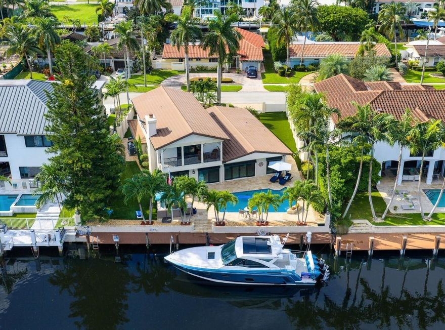 An idyllic lifestyle awaits at this Island-Inspired Deepwater Estate sited on 80’ of waterfrontage in the sought-after enclave of Lighthouse Point. Newly appointed designer interiors reveal 4 beds, 3 Full Baths, 1 Half bath, office & 3,226 living Sq. Ft. Impressive foyer entrance leads into a light-filled open floorplan featuring great room w/fireplace, guest suite, cabana bath & luxe kitchen overlooking waterway. Three bedrooms upstairs including large primary suite with private waterfront balcony. Amenities include fully outfitted 2 bay garage, new roof in 2019, new pavered driveway, gutters, 2 zone a/c and impact windows. Outdoor entertainment is enjoyed at the pavered patio w/resort style pool surrounded by turf and lush landscaping. Full-service yacht dock minutes to the intracoastal. DISCLAIMER: Information published or otherwise provided by the listing company and its representatives including but not limited to prices, measurements, square footages, lot sizes, calculations, statistics, and videos are deemed reliable but are not guaranteed and are subject to errors, omissions or changes without notice. All such information should be independently verified by any prospective purchaser or seller. Parties should perform their own due diligence to verify such information prior to a sale or listing. Listing company expressly disclaims any warranty or representation regarding such information. Prices published are either list price, sold price, and/or last asking price. The listing company participates in the Multiple Listing Service and IDX. The properties published as listed and sold are not necessarily exclusive to listing company and may be listed or have sold with other members of the Multiple Listing Service. Transactions where listing company represented both buyers and sellers are calculated as two sales. “No payments made until title passes” Some affiliations may not be applicable to certain geographic areas. If your property is currently listed with another broker, please disregard any solicitation for services. Information published or otherwise provided by seller, listing company or its representatives is deemed reliable but are not guaranteed and subject to errors, omissions, or changes without notice. Copyright 2025 by the listing company. All Rights Reserved.