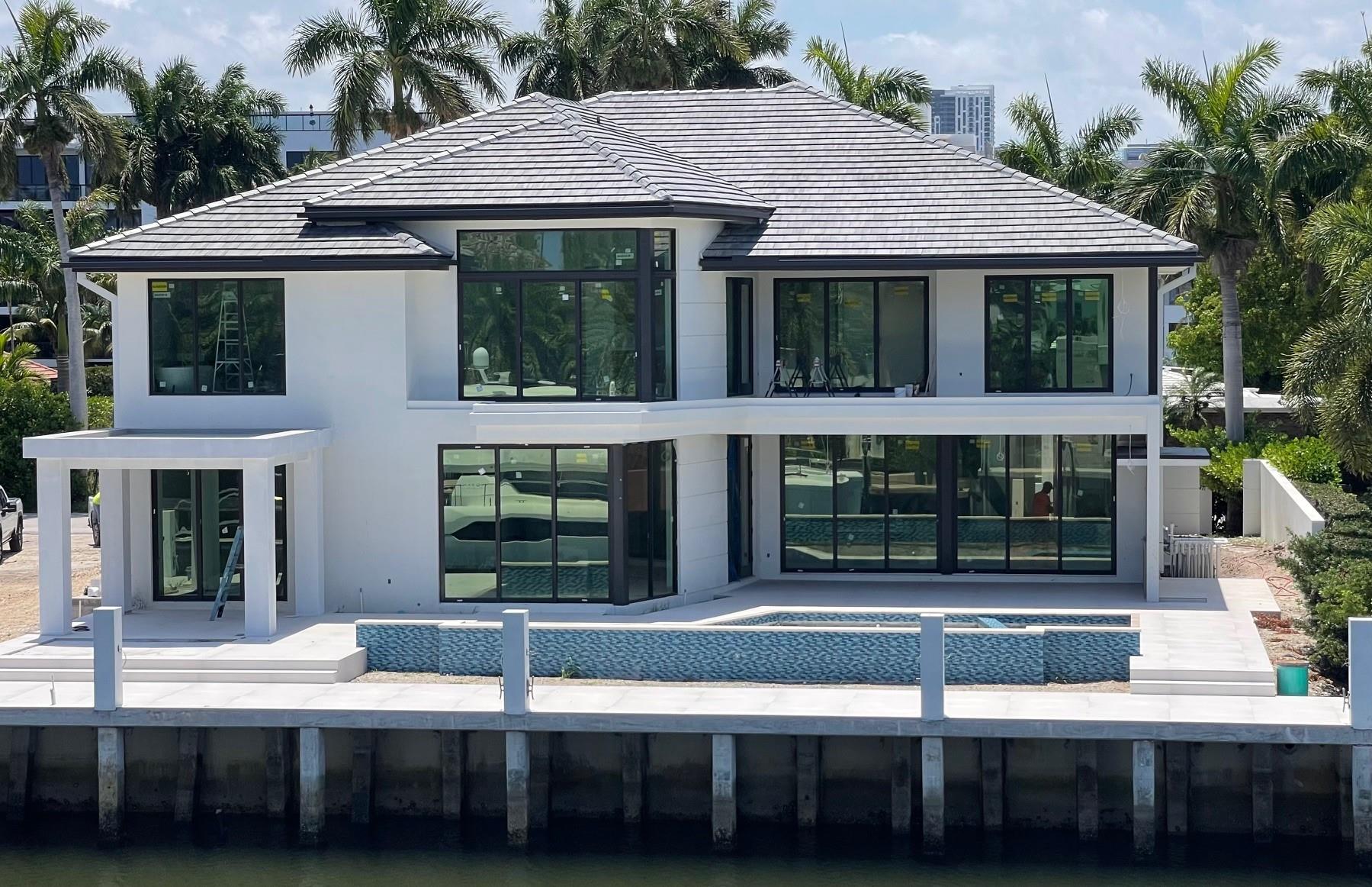 NEW CUSTOM HOME, WATERFRONT AND GATED! Walk to Las Olas Blvd shops, restaurants and beach. Contemporary Coastal Modern design w/green court entry, 2 story foyer, spacious grand room with dining features, fireplace w/wine wall, modern elevator, family room w/views of pool-waterfront, outdoor loggia with chef's station and bar, top of the line kitchen, AND butler's kitchen. VIP guest suite, plus study/office/bed on 1st Level. 2nd floor includes expansive concierge area w/TV and refreshment center, modern main suite w/curved glass wall, panoramic views and terrace, main bath with his/her vanities, showers and bathtub, large walk-in-closet, plus 3 beds, 2 laundries, 3 Car Garage, telescopic drive gates, covered pedestrian gate, 85 feet dock for up to 65 foot yacht. Ready by September 1st, 2025