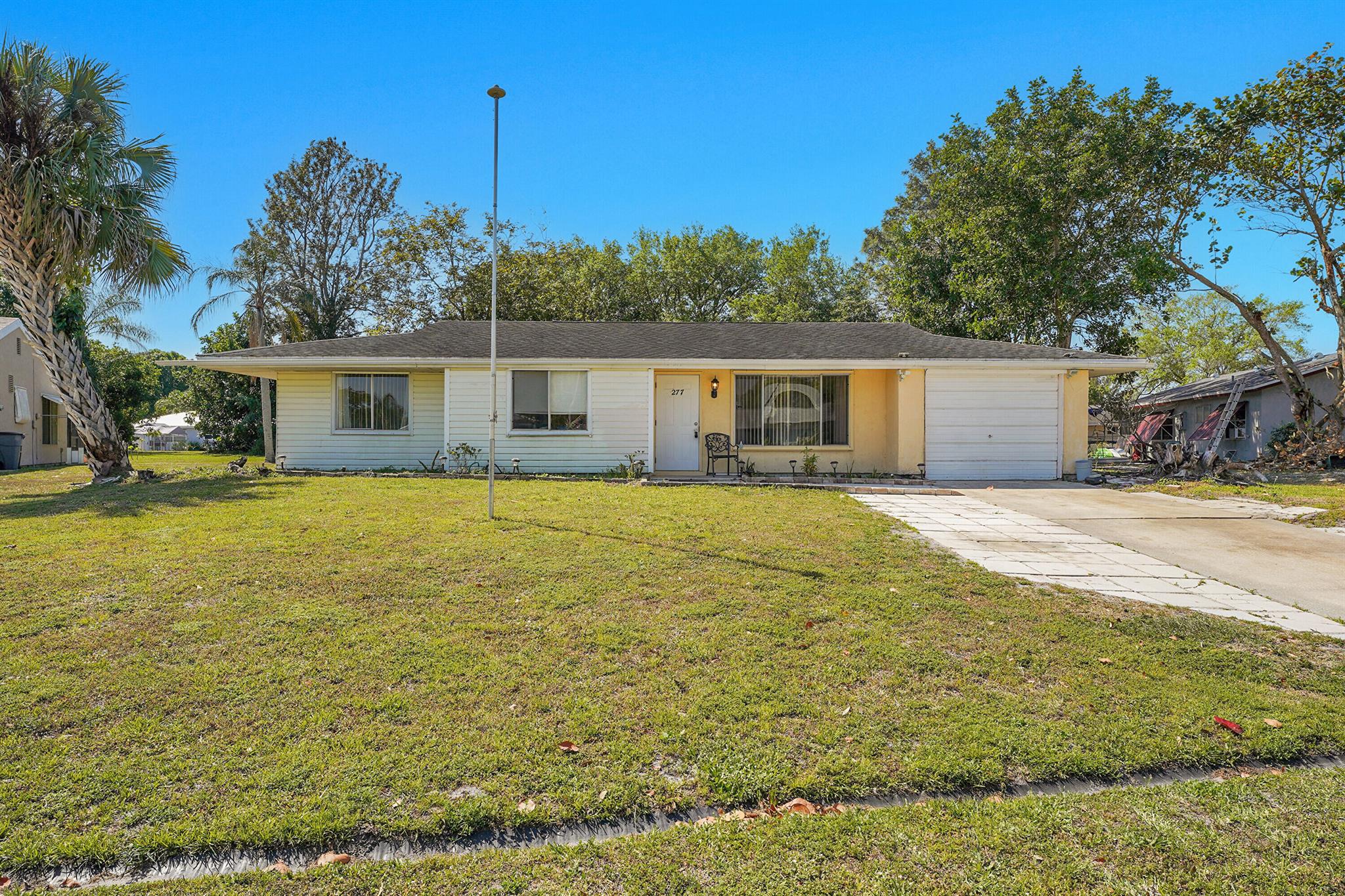 Welcome to 277 SW Kimball Circle in sunny Port Saint Lucie!This charming single-family home offers 3 bedrooms, 2 bathrooms, and a comfortable, functional layout perfect for everyday living or future investment. Sitting on a generous lot, there's plenty of room to customize, expand, or simply enjoy the Florida lifestyle your way.Key updates, like a newer A/C system, add peace of mind, while the prime location keeps you close to shopping, dining, schools, and medical facilities. Whether you're a first-time buyer, downsizer, or savvy investor, this property is full of potential and ready for your next chapter.Bring your vision and make this house your next move! Call now for a private tour.