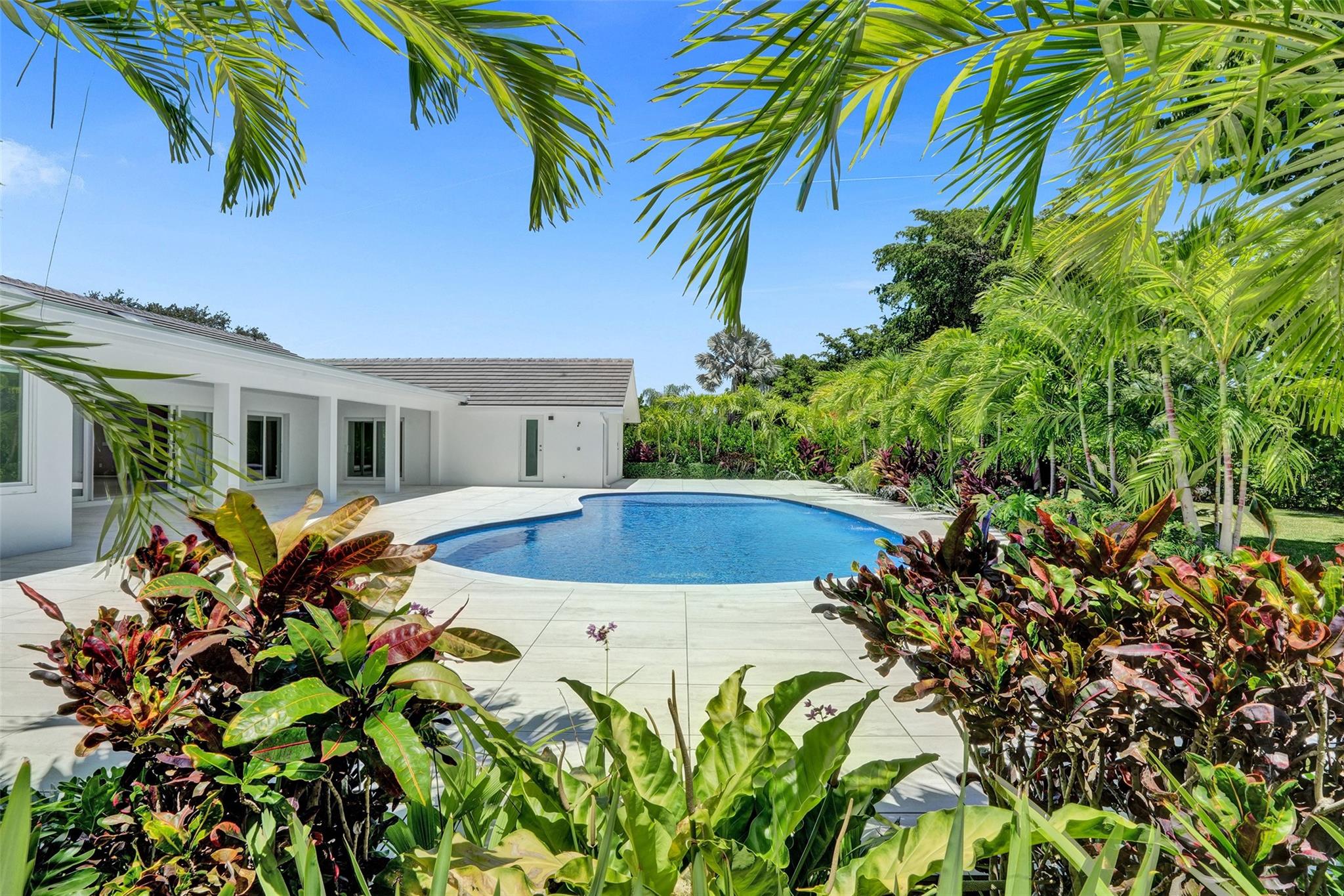 Set within the prestigious, guard gated enclave of Boca Bath & Tennis, this reimagined masterpiece has been meticulously rebuilt to the absolute highest level. A breathtaking open concept floor plan allows for entertaining with truly no limits. The oversized chefs kitchen features a 16’ x 5’ natural stone island, European cabinetry throughout + professional grade Thermador and Miele appliances, including a 94 bottle Thermador wine refrigerator. 4 spacious bedroom suites, each with its own en suite bath finished in elegant Porcelanosa European tile, plus two additional powder rooms. The private home office overlooks the resort style pool lounge + rear yard areas. A custom walk-in laundry with European cabinetry + wash sink completes this remarkable luxury estate. Let's Take A Look...