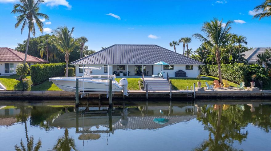 Welcome to this completely reimagined waterfront residence in the highly sought-after Soundings community of Hobe Sound. Boasting 105 feet of wide-water frontage with no fixed bridges, this exceptional home has been fully renovated from top to bottom, offering a sleek, modern design and effortless coastal living. The interior was opened up and thoughtfully redesigned to create a fresh, light-filled layout perfect for entertaining and everyday comfort. Glossy marble and rich wood floors enhance the home's elegant design throughout. Enjoy peace of mind with a new metal roof, new PGT impact windows & slider screens, new mahogany front door, and a 250-gallon propane tank. Outside, the property shines with a brand-new saltwater pool with heater/chiller and impressive deck, a new dock    and a 16,000 lb boat lift accommodating up to a 34-foot boat... a true boater's dream. The Soundings is a waterfront community known for its amenities, including a clubhouse, dog park, pickleball and tennis courts, community pool, and boat/RV storage yard. Ideally located, Hobe Sound offers a charming small-town feel while being just minutes from Jupiter and Stuart, with easy access to beaches, golf, top-rated schools including The Pine School, shopping, dining, and hospitals. This is a rare opportunity to own a turnkey, modern waterfront home in one of the Treasure Coast's most desirable communities.
