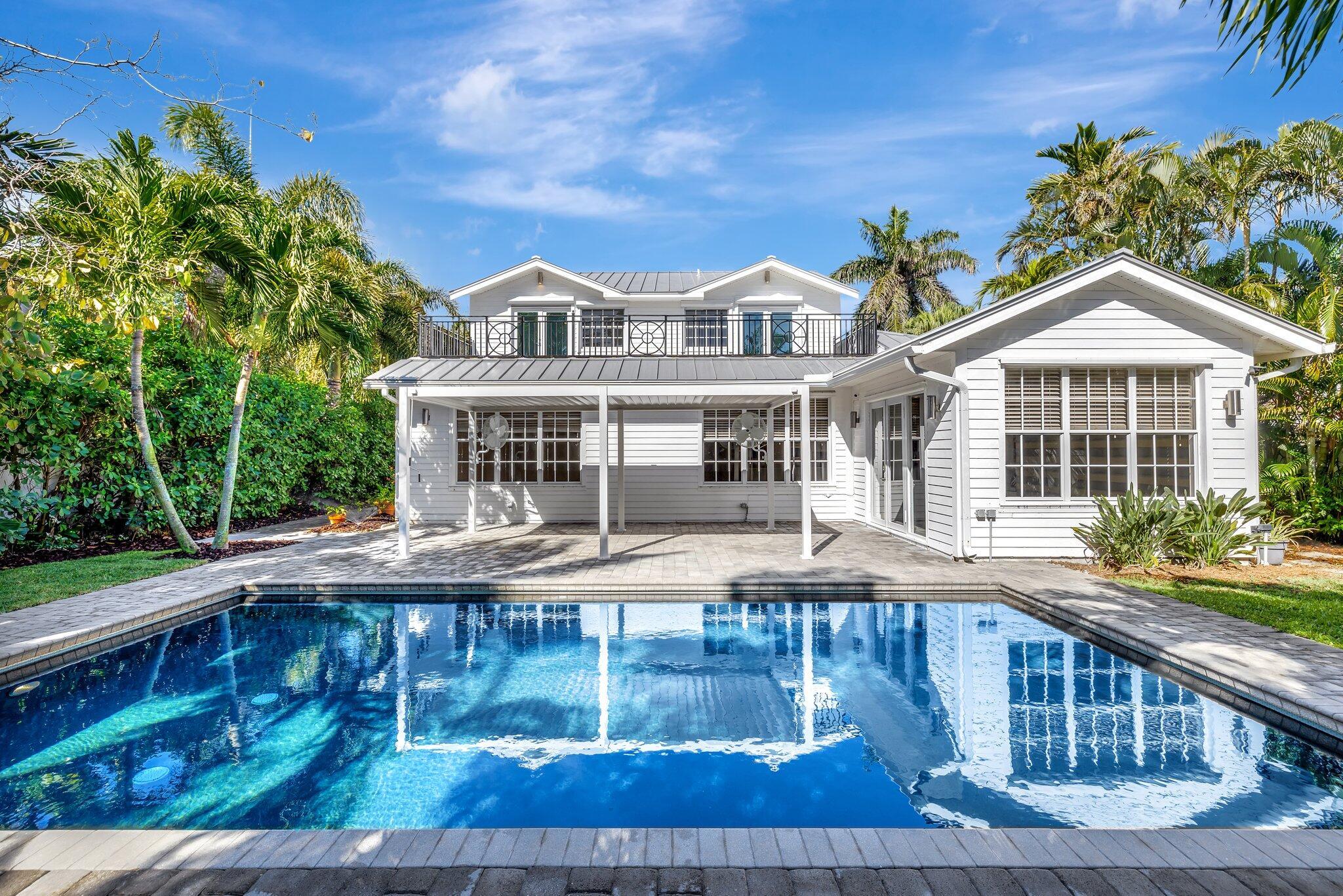 Indulge in luxury living on exclusive Hypoluxo Island! This magnificent 5-bedroom, 4-bathroom residence exudes elegance across two spacious stories. Enter into an expansive open floor plan, where an oversized gourmet kitchen awaits, featuring custom white shaker cabinets and stunning Carrera marble countertops--ideal for entertaining. The primary suite and a guest room are conveniently located on the first floor, each adorned with lavish updated marble bathrooms. A two-car garage offers both convenience and ample storage. Step outside to your private paradise, complete with a heated saltwater pool surrounded by lush tropical landscaping, perfect for sophisticated gatherings. Close to pristine beaches, upscale dining, boutique shopping and short distance to the Breakers and PBI airport.
