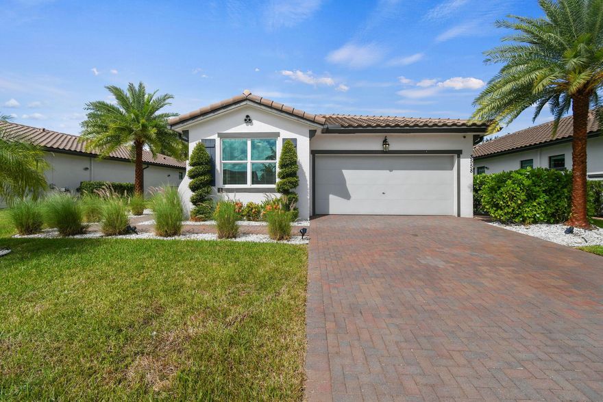 This beautifully appointed 3-bedroom, 2-bathroom residence with a 2-car garage offers the perfect opportunity for year-round living just seven minutes from the equestrian heart of Wellington. Built in 2020, the home features an open and inviting floor plan with abundant natural light, impact-rated windows and doors, electronic window treatments, custom wall paneling, GE Profile appliances, a large kitchen island with designer hood, and a stylish backsplash that elevates the space. Smart-home features and cost-saving solar panels enhance day-to-day living. The private turf backyard, covered lanai, outdoor kitchen, and resort-style saltwater heated pool with jacuzzi provide an effortless indoor-outdoor lifestyle perfect for relaxing or entertaining year-round.