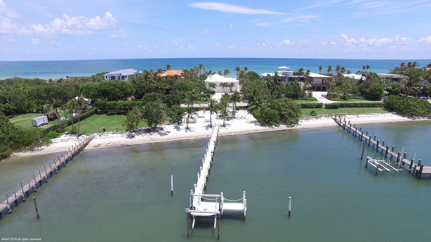 Completely renovated in 2007, this Ocean to Intracoastal property on the southern end of Jupiter Island offers almost 200' of water frontage. The beautiful pool area on the ocean provides ample space for sunning, dining and relaxing. In addition to the beach on the ocean, there is an expansive sugar sand oasis on the Intracoastal which includes a canopied cabana perfect for candlelit dinners or large parties. Adjacent to this is a deep water dock and proximity to the Jupiter Inlet allow for unfettered access to the ocean.  Each bedroom on the main floor main house has access to the resort like pool area and there are wide open views of water on every side. Downstairs, there is a separate in-law/guest/or staff quarters which includes an enormous bedroom, sitting room and bathroom.
