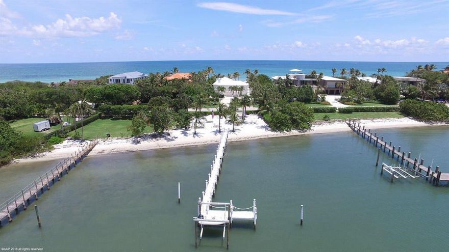 Completely renovated in 2007, this Ocean to Intracoastal property on the southern end of Jupiter Island offers almost 200' of water frontage. The beautiful pool area on the ocean provides ample space for sunning, dining and relaxing. In addition to the beach on the ocean, there is an expansive sugar sand oasis on the Intracoastal which includes a canopied cabana perfect for candlelit dinners or large parties. Adjacent to this is a deep water dock and proximity to the Jupiter Inlet allow for unfettered access to the ocean.  Each bedroom on the main floor main house has access to the resort like pool area and there are wide open views of water on every side. Downstairs, there is a separate in-law/guest/or staff quarters which includes an enormous bedroom, sitting room and bathroom.