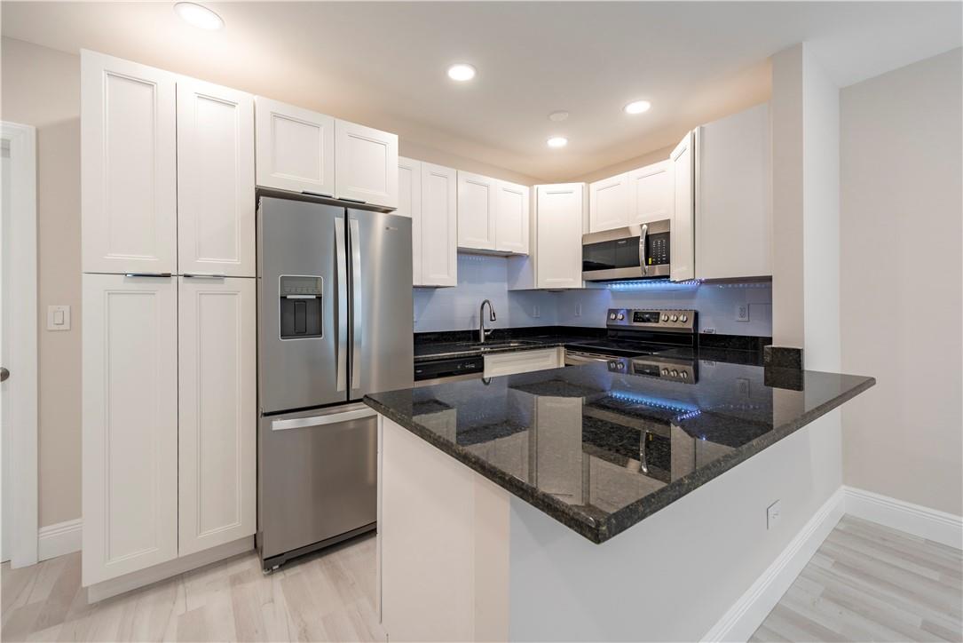 Beautifully remodeled Victoria Park apartment that checks all of the boxes with a modern design. The open kitchen is highlighted by an oversized "dine-in" granite counter top, Whirlpool & Frigidaire appliances, dimmable high hat ceiling lights, and 42" white shaker cabinetry. A spacious bedroom with an oversized window provides ample daylight, a walk-in closet, and its own AC. The en-suite bathroom is complete with a modern vanity, excellent lighting, and glass enclosed spa shower. Other property features include hurricane impact windows and doors, secure gated entry, utility laundry room, tankless hot water heater and (2) Mini Split AC units providing efficient zone cooling. Walking distance to Holiday Park, Las Olas, downtown, and the beach!