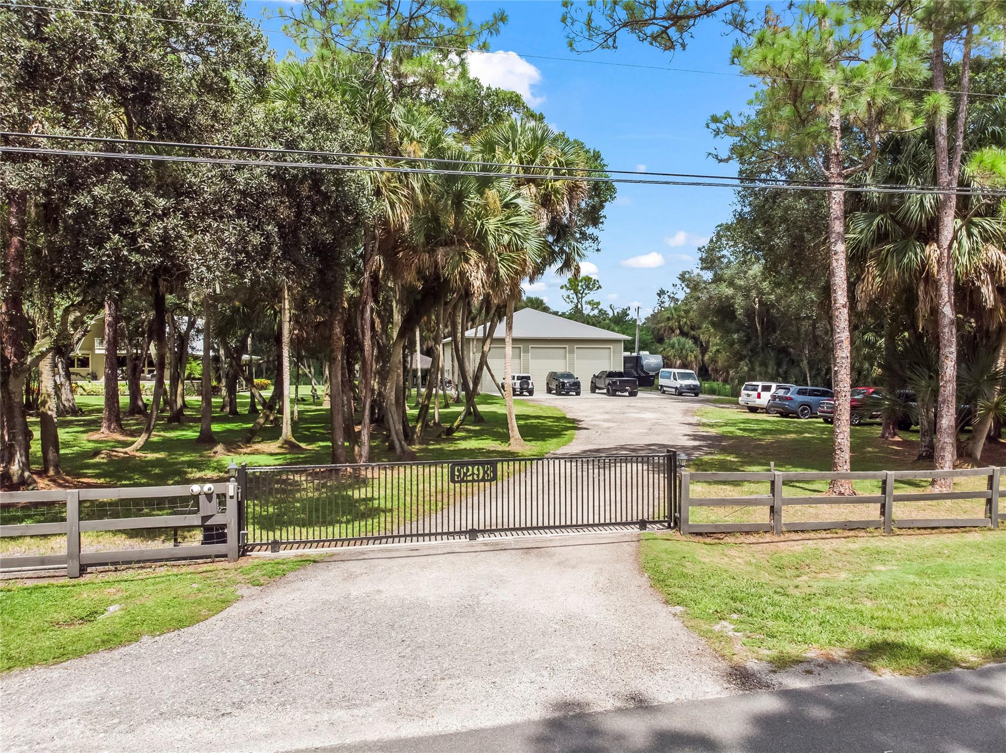 BEST Location in sought after section 7 of Jupiter Farms! 2.5 acres of meticulously maintained property with access from a paved road. Opportunity for Business Owners who see the value working from home. Bring your Motorcycles, Buses, Trailers, Trucks, Boats, Motor Homes. NO HOA- 3 bedroom, 2 bath Cedar Lindal built log cabin home PLUS a 50x50 - 2500 square foot air-conditioned commercial grade construction block building with (3) 12x14 bays and one regular size garage door. 2 zone A/C throughout & kitchenette & bathroom PLUS a 2nd level with finished offices for multi-purpose usage. PLUS a 40 x 40 tiki hut with electricity. Ride your bikes to River Bend Park. Experience the serenity of nature, owls, hawks, peacocks & wildlife. Land + buildings = A POSITIVE EQUITY PURCHASE