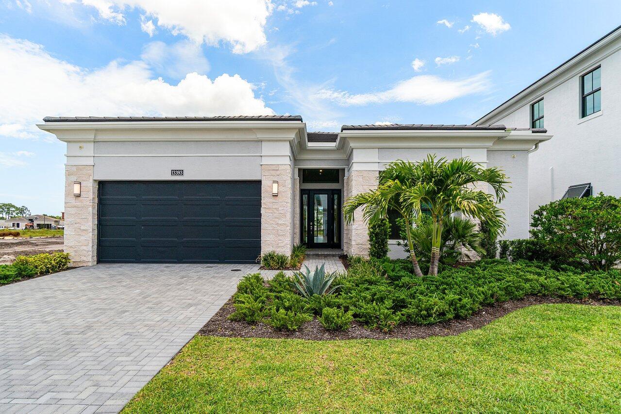 Welcome to your dream home in Artistry Palm Beach where luxury and lifestyle meet with over $370K in high-end upgrades, including a custom pool & spa, travertine deck, and full outdoor summer kitchen. Inside, enjoy wide-plank flooring throughout, 71/4'' crown moulding, solid core doors, and a chef's kitchen with quartz waterfall island, Monogram appliances, pot filler, and designer backsplash. The spa-inspired owner's suite features a jetted tub, frameless shower, Toto bidet, and quartz counters. All bathrooms are fully upgraded. Additional features include smart garage opener, epoxy flooring, LED lighting, and privacy fencing. Move-in ready and truly exceptional!