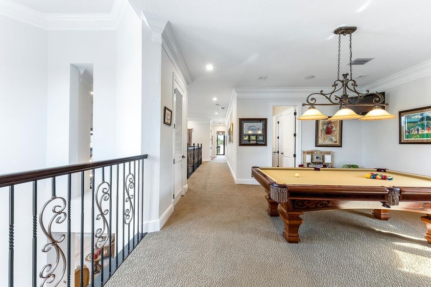 Magnificent custom home in PGCC. This mini mansion offers 6 bedrooms. (7th bedroom opens to pool table loft) Master down, 5.5 bathrooms. Gourmet kitchen w high level cabinets, granite, dbl ovens, warming drawer, Miele cappuccino system, 2 dishwashers, 2 pantries & separate eating area overlooking rolling fairways, tranquil water & stunning pool area w a tremendous patio. Soaring ceilings, living room opens to 2nd level, formal dining rm, pool table rm & huge movie theater. 2 balconies, 1 facing front, 1 overlooking the gorgeous landscape & the back w extensive views of the golf course, waterways. Heated pool w new salt system, Newer 3 AC's. Attention to detail throughout homk, custom closets. Impact windows & doors. Landscaping lighting & beautiful landscape. Luxury living in Parkland Golf