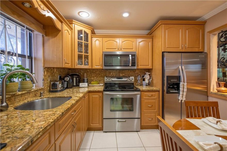 Beautiful corner unit with peaceful lake views. Completely remodeled condo, new kitchen with SS appliances, wood cabinetry and granite countertops, tile throughout the entire unit, new bathrooms, 4 year old A/C unit, new electric water heater, accordion shutters, crown molding, washer and dryer inside the unit and painted a neutral color. The apartment is in a gated community and close to everything. Not subject to appraisal. Price is firm.