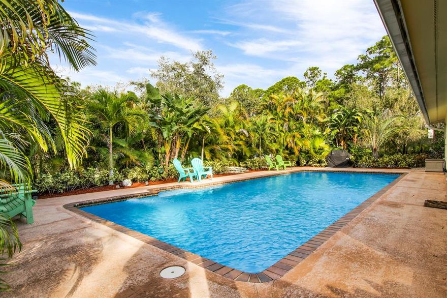 Truly MOVE IN ready!  Come out to the country & bring your animals AND all your toys!  This updated single story pool home offers 3 bedrooms and 2 baths, a bonus room with inside laundry room, large front porch and screened back patio overlooking the private pool!  The inside has been completely updated including NEW kitchen with granite tops and white shaker cabinets, Stainless Steel Appliances, NEW flooring, 2 NEW bathrooms (Master bath offers a free standing tub, dual vanity, new shower enclosure.  Guest Bath offers a shower and pedestal sink).  The 1.5 acre property is fully fenced with an electric gate and has an assortment of native trees which add shade and beauty.  There is plenty of parking in the large driveway and a 900 sq ft detached garage/utility building is the perfect spot to store all your toys.  Truly nothing to do here but MOVE IN ... Lots of trees offer great shade and beauty.  Extras include a wood burning fireplace, vaulted ceilings with tongue and groove detailing.  New paint!  NO HOA - bring pets - boats - toys - trucks

New AC (4.5 ton) - New pool pump - New SS Appliances - Hurricane Protection (panel shutters) - New water system, including pump. Roof 2006. **Sellers will either need a delayed closing (approx May) or a lease back situation.