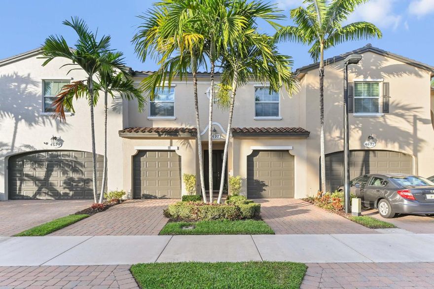 Located in the gated community of Trevi at The Gardens, this spacious 2-story townhouse offers 1,718 sq ft of living space with serene community pool views. The home features 3 bedrooms, 2.1 baths, and a welcoming foyer entry. The main level boasts an open living floor plan. 2 split garages with separate entrances.

The kitchen is equipped with wood cabinets with crown molding, granite counter tops, and stainless steel appliances, offering both style and functionality. A convenient laundry room with a washer and dryer is also located on the 2nd floor for practical use. All bedrooms are situated upstairs for added privacy and feature carpeted flooring. The large master bedroom provides a comfortable retreat, while the split bedroom layout includes a Jack and Jill bathroom. Additional highlights include impact glass throughout and the security of a gated community.

Enjoy comfort, space, and a prime location in this well-maintained townhome at Trevi at The Gardens.