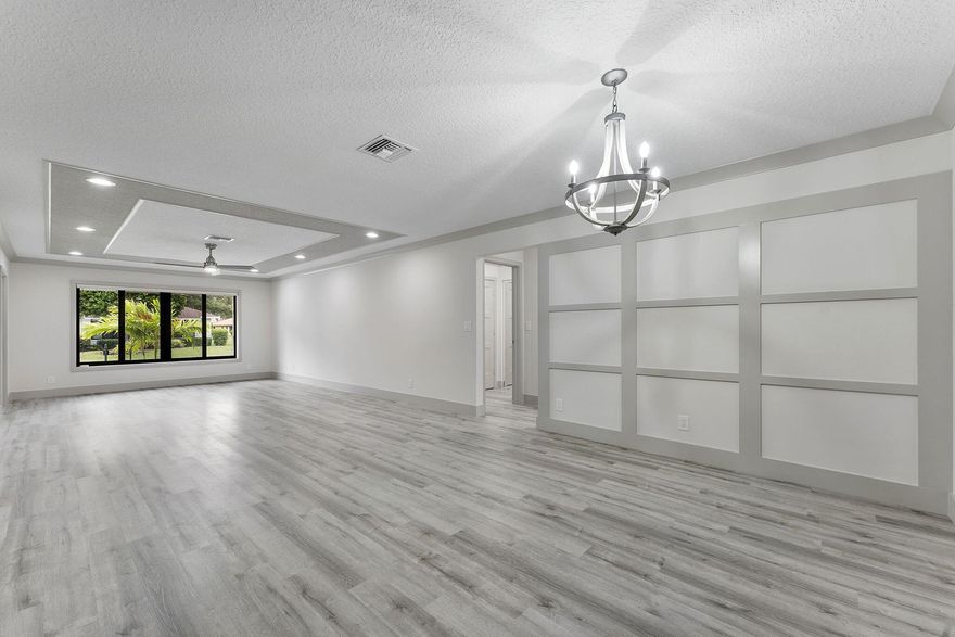 THE MOST EXTENSIVE FLOOR TO CEILING RENOVATION TO HIT THE MARKET IS NOW READY FOR YOU.  OPEN CONCEPT LAYOUT WITH LOTS OF NATURAL LIGHT, PREMIUM LOT WITH WIDE GREEN VIEW & EXTRA LONG DRIVEWAY. SOME OF THE MANY BRAND NEW EXTENSIVE IMPROVEMENTS ARE: ALL HVHZ IMPACT GLASS, IMPACT GARAGE DOOR W/ NEW WIFI MOTOR, IMPACT FRONT DOOR, PORCELAIN & LVP FLOORING, KITCHEN, BATHS, PREMIUM APPLIANCES, W&D, PREMIUM WOOD CABINETRY, ISLAND W/ WATERFALL QUARTZ TOPS, DECORATOR ACCENTS, RECESSED LED LIGHTING THROUGHOUT, R38 INSULATION, INT DOORS, TRIM, CROWN, DESIGNER MOLDINGS, HUNTER DOUGLAS BLACKOUT WINDOW TREATMENTS, A/C COVERED PATIO CAN BE ENJOYED YEAR ROUND, 8X16 BRICK PAVER OPEN PATIO, NO EXPENSE SPARED!  JUST LOOK AT ALL THE DETAILS IN THE PHOTOS!! BRAND NEW ROOF IN 2026 ALREADY PAID FOR.