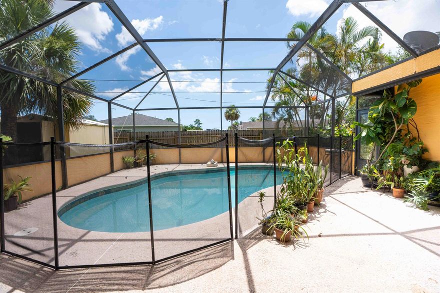 Located in the heart of Port St. Lucie and just minutes from the shops, dining, and events of Tradition, this 3 bedroom, 2 bathroom pool home offers an incredible opportunity for a buyer looking to add value and make it their own.The home features a screened-in inground pool, perfect for year-round enjoyment, and a fully fenced backyard with a storage shed--ideal for extra storage or a workshop. A beautiful circular driveway adds to the curb appeal and provides ample parking for family and guests.Inside, you'll find a spacious layout with great bones and natural light throughout. The master bathroom is ready for renovation, giving you the opportunity to create a custom space tailored to your style. While the home would benefit from updates, it has excellent potential as a primary