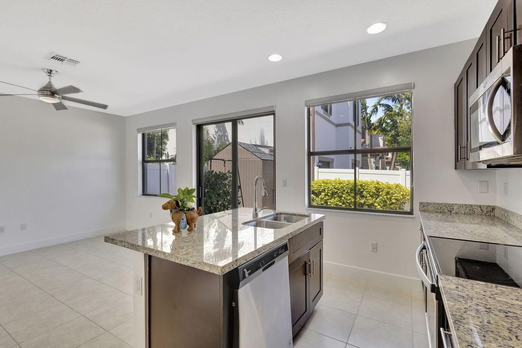 Photo of 6028 Pine Tree Way, Riviera Beach, FL 33410 (MLS # R11107090)