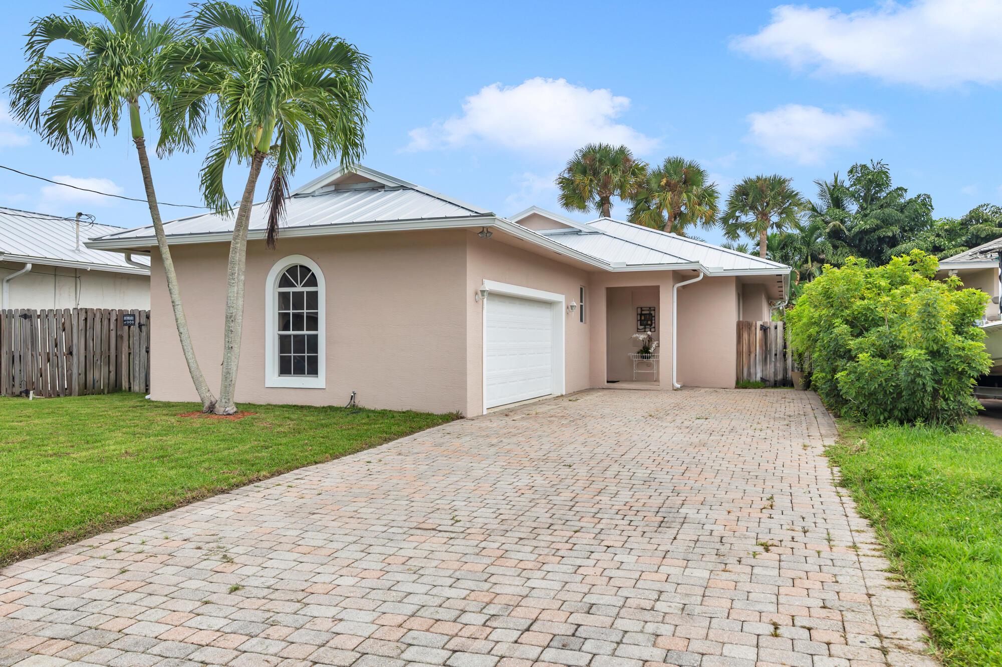 Charming 3 bedroom, 2 bath home located in the heart of Jupiter with no HOA. This lovely home boasts a new roof, updated appliances, granite counter tops and tile in the main living areas. The home has an open floor plan in the living area overlooking a private screened patio and private fenced yard. The 2 car garage and large driveway will allow for multiple vehicles to be parked on the property. Light and bright, this home offers the convenience of being located in the heart of Jupiter, close to and walking distance to shops, banks, restaurants and the dog park. Jupiter's beautiful beaches are a short distance away. There is no HOA in this community.