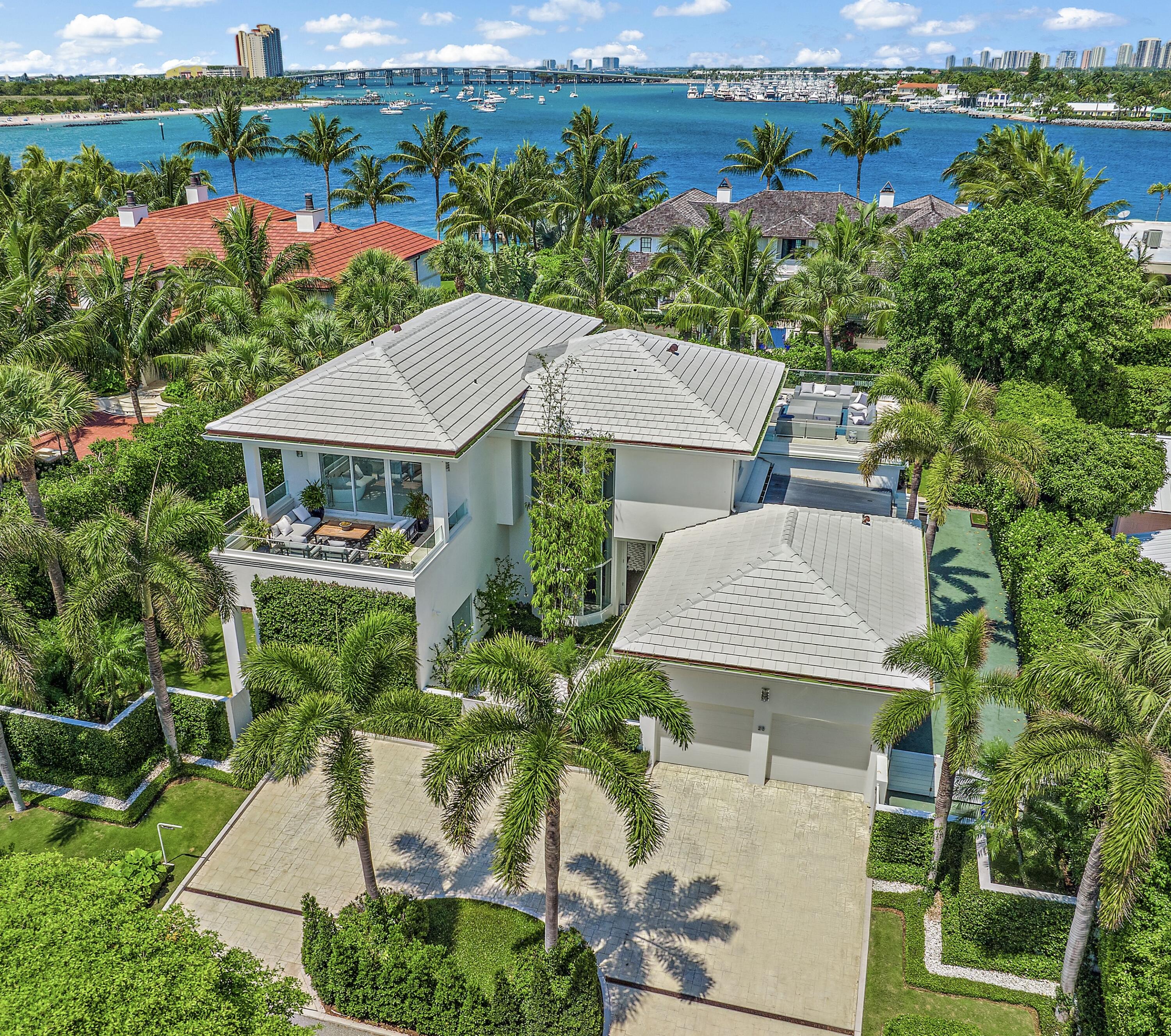 Re-imagined by Todd Michael Glaser, this modern masterpiece on the North End of Palm Beach has nearby beach and Intracoastal Waterway access. Ideal for early morning walks, surfing, kite boarding & multiple leisure & contemplative pursuits. This chic 5 bedroom with 5.1 bath residence features over 7,000 total square feet, floor to ceiling windows, a stunning floating glass staircase, high ceilings throughout, a new gourmet eat-in-kitchen, & a spacious primary suite with a sitting room. Stylish, glass railing upper deck with water views is a highlight of this residence & is perfect for entertaining. A 2-car garage new impact windows & doors, new floors, new roof, & manicured landscaping completes the offering. A Palm Beach jewel.