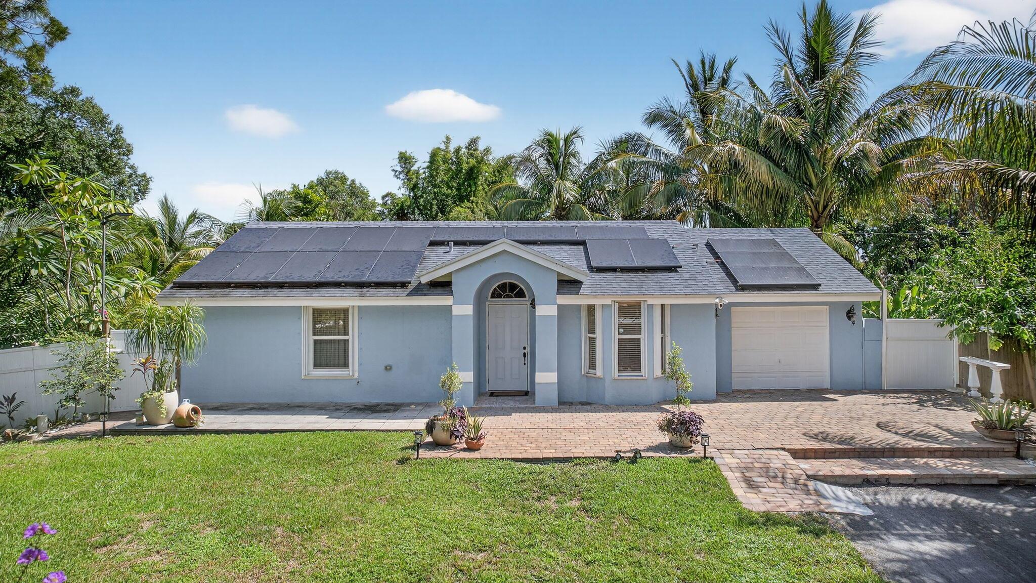 Immaculate 3/2 pool home on 1.59 acres. Open floor plan, abundant natural light, freshly painted neutral color. Move-in ready, tile floors throughout. Updated kitchen with sleek countertops & brand new kitchen appliances. Stylish remodeled bathrooms. Relax or entertain in your backyard paradise featuring salt water chorination pool, 2 Tiki bars, lush variety of mature fruit trees including mango, coconut, bananas,guanabana,almond, sugar cane, etc. Peaceful and private lot.New roof 2022, AC 2020, All impact windows, R/O water filtration system 2025, new blacktop driveway.2 RV hookups (sewer, water, electric)