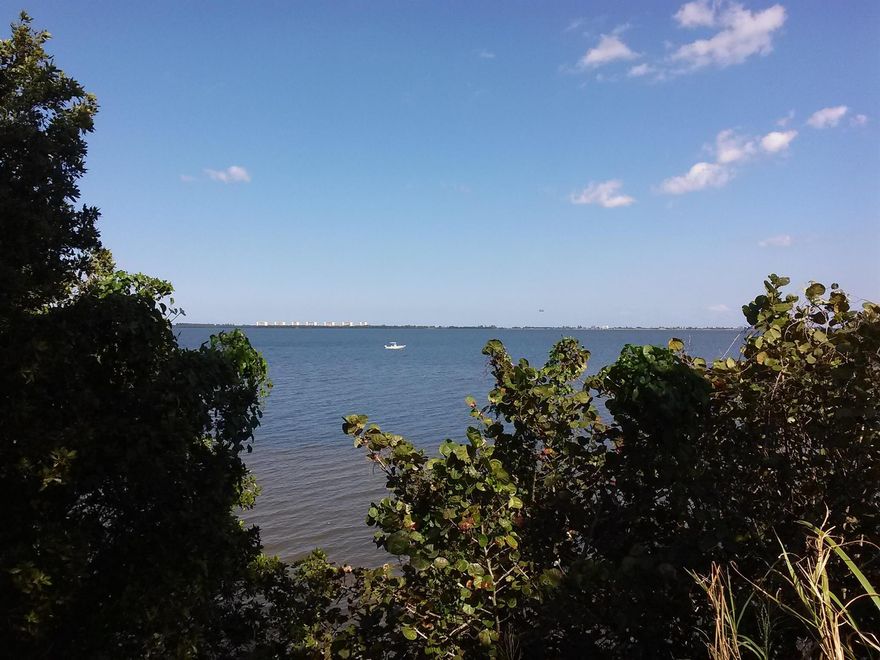 EXCLUSIVE WATERFRONT OPPORTUNITY! Discover a rare, one-acre single-family waterfront lot, uniquely surrounded by 41 acres of protected government land guaranteeing absolute privacy with no future neighbors. This is your chance to own a piece of untouched, old Florida paradise, where natural beauty meets exceptional value. This premier RE-2 zoned property boasts an impressive 24-foot elevation above sea level, offering peace of mind and breathtaking views. Design your dream estate up to 8,538 square feet or create two structures to suit your vision, all while maintaining the exclusivity and privacy that make this site truly one-of-a-kind.  Enjoy full riparian rights with the opportunity to apply for your own dock, perfect for boating enthusiasts and sunset seekers alike.