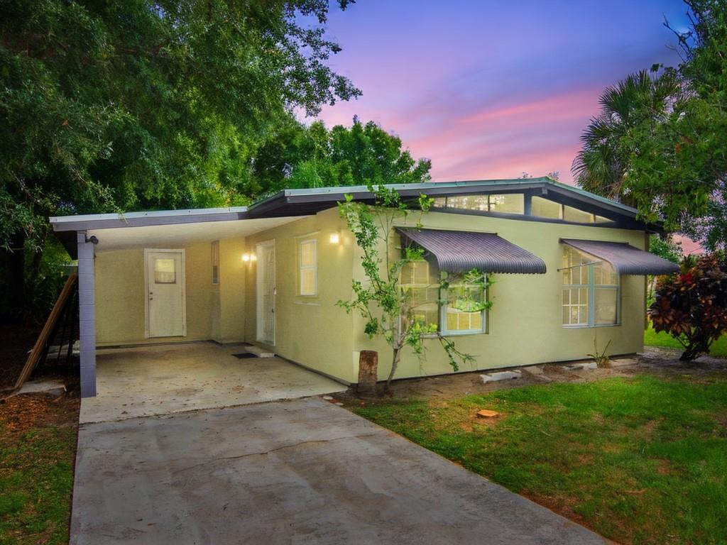 Income Property... Charming 2 bed, 1.5 bath concrete block home on a large corner lot in a safe & quiet neighborhood. Features incl: 2017 metal roof, updated 2017 electric panel, refinished terrazzo floors throughout, central A/C (2016), ceiling fans in every room & a freshly painted interior. Enjoy the air-conditioned Florida room, separate laundry space, and rinse off after the beach in the outdoor shower. Just minutes from beaches, dining, and shopping. Great income potential—perfect for first-time homebuyers or investors seeking comfort, convenience & coastal living.