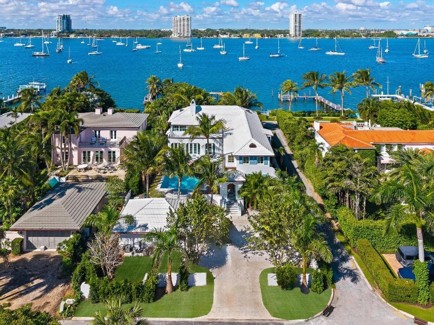 Spectacular Newly Completed Lakefront home with deep water dock and access to the Lake Trail. With spectacular views of the Intracoastal, this stunning home has been beautifully restored and features 5 bedrooms, 7 bathrooms, 1 powder room, and over 6,800 total square feet. Fabulous courtyard pool area perfect for outdoor entertaining with covered loggia, expansive patio, salt-water pool, and spa. Interior highlights include formal dining room, fabulous eat-in kitchen, media room, and den. Beautiful Primary Suite with dressing room, large bath with dual sinks, and breathtaking views. Additional features include lush tropical landscaping, 2-car garage, multiple balconies, and charming entry portico.