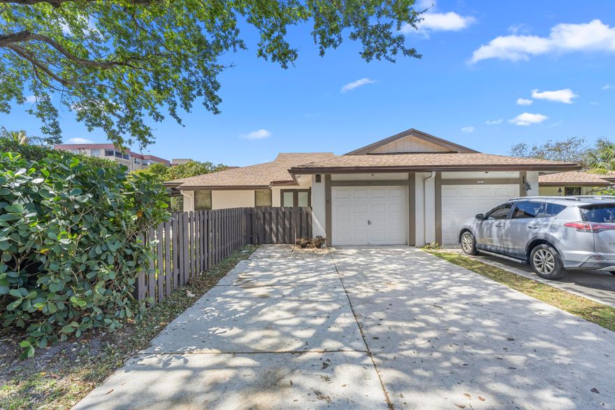 THI HOUSE REALLY DELIVERS! ALL THE BELLS AND WHISTLES!  TURN KEY BEGINS HERE!  Spacious and gracious 3 bedroom 2 bath home with garage.  Shared wall but feels like a single family home with garage, porch and fenced yard.  Designer kitchen with 42 inch white cabinets, crown molding and quartz countertops.  New appliances December 2025: top of the line refrigerator plus stove and dishwasher.  If you love to entertain, this bright open floor plan is perfect.  Large dining area, plus screened porch off the kitchen. Elegant large porcelain like tile in a soft beige shade throughout the living areas. NO popcorn ceiling here, removed with new knockdown ceiings 10/2022.   NEW ROOF: 2023   IMPACT DOORS AND WINDOWS: MAY 2023+.  Fence landscaping, pavers 2023/2024.   Community pool and park.