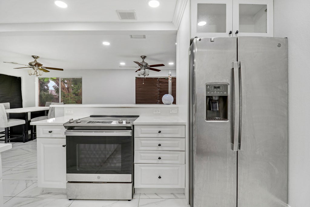 Photo of 935 Orange Drive, Lake Park, FL 33403 (MLS # R11151377)