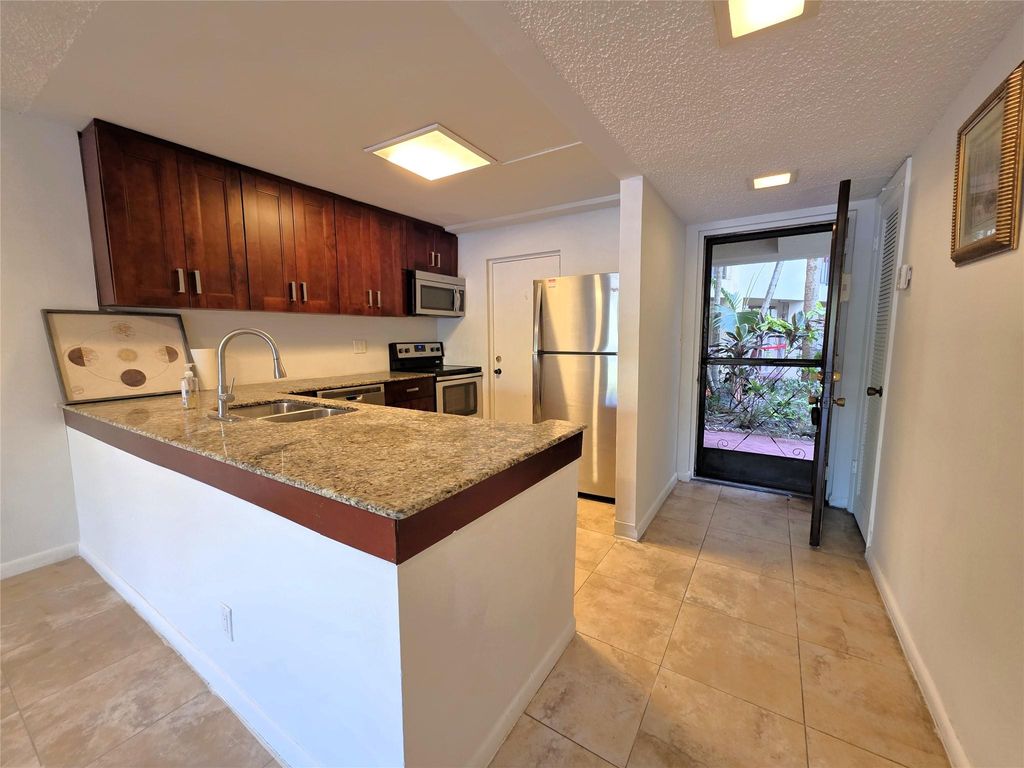 Photo of 2320 S Cypress Bend Drive #106, Pompano Beach, FL 33069 (MLS # F10520183)