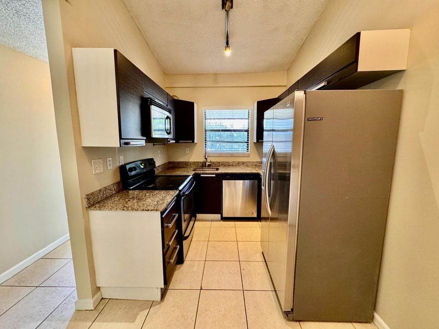 Discover this beautifully maintained 2-bedroom, 2-bathroom home featuring tile flooring throughout, fresh paint, and modern stainless steel appliances. Enjoy the convenience of a full-size washer and dryer right inside the unit. Pets are welcome, making it perfect for your whole family. Ideally located near restaurants, entertainment, and shopping, this residence offers both comfort and convenience. Ready to move in—schedule your showing today!