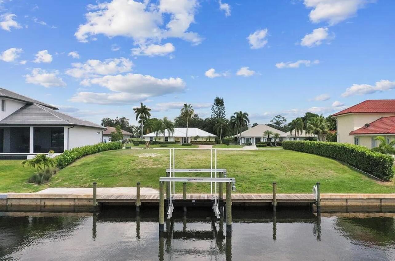 Welcome to coastal living! This stunning waterfront lot features ample space to build your dream waterfront estate. With an existing seawall, dock, and boat lift, along with power and water connections already in place. The generous lot size provides endless possibilities for customization, design, and construction. You'll love the easy water access to Manatee Pocket and Stuart Inlet. Situated within the exclusive Gated Yacht and Country Club of Stuart, luxury meets coastal living at its finest. Residents enjoy access to top-notch amenities, including an 18-hole championship golf course, tennis courts, a fitness center, and fine dining. SEE SUPPLEMENTAL REMARKS