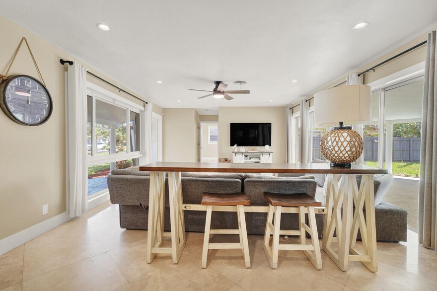 Fully renovated and move-in ready, this stunning home sits on a spacious corner lot in the highly desirable Imperial Point neighborhood. ( NO HOA ). The property features full hurricane protection with impact-rated windows and a front door.  Inside, you'll find tile flooring throughout and a bright, open layout enhanced by southern exposure and abundant natural light streaming through four sets of sliding glass doors. The home features scraped popcorn ceilings, modern LED lighting, updated fixtures, renovated bathrooms, a beautifully updated kitchen, new washer / dryer, and a 2023 A/C system. The custom gourmet kitchen is a standout, featuring wood cabinetry, quartz countertops, and new appliances, including a Bosch microwave.  This split floor plan provides privacy and spacious rooms, making it ideal for families or hosting guests. Step outside to a fully fenced backyard with an oversized patio, offering ample space to add a pool or enclose for additional living area. A large side gate adds convenience, allowing easy storage for RVs, boats, or work vehicles. Imperial Point is a well-established and highly desirable community offering convenient access to US-1 and I-95, making commuting a breeze. Ideally located just minutes from Downtown Fort Lauderdale (Las Olas), Fort Lauderdale-Hollywood International Airport, and the beaches of Lauderdale-by-the-Sea. Enjoy close proximity to top-rated restaurants, shopping, marinas, and premier boating access. Perfect for embracing the South Florida lifestyle. With no HOA and no restrictions, this property offers exceptional flexibility for homeowners and investors. Ideal for annual or seasonal rentals, with strong Airbnb potential in a high-demand location.