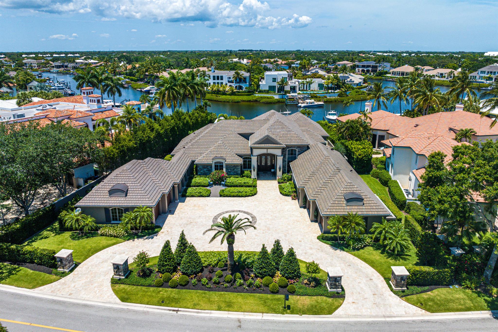 Indulge in waterfront luxury at this French-inspired masterpiece in Admirals Cove. Seamlessly blending traditional elegance with modern sophistication, this single-story haven exceeds expectations. With cutting-edge technology, including a Vantage lighting system and integrated sound, every detail enhances the ambiance. The dream kitchen boasts top-of-the-line appliances, while the backyard oasis offers a pool, spa, and captivating flame burning urns. Additional features include an office, guest house, and media room. Meticulous attention to detail and exquisite craftsmanship are evident throughout. Experience the opulence of this home in person and embrace refined luxury. Welcome home.