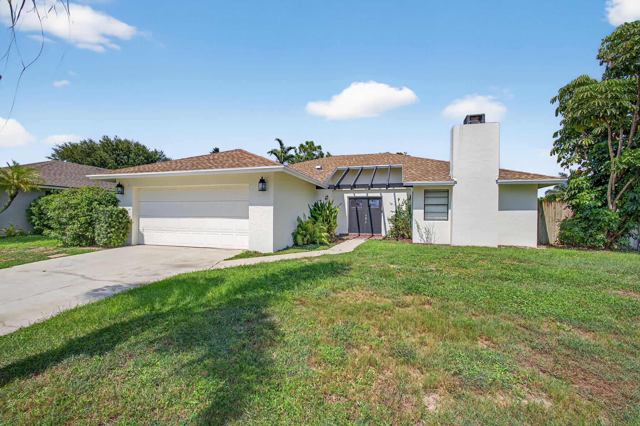 Rare Find in the Heart of Wellington - No HOA! This beautifully renovated home is a true gem in Wellington, offering A-rated schools and the freedom of no HOA restrictions. Nestled on navigable water, enjoy peaceful days canoeing, kayaking, or boating with access to Lake Wellington right from your backyard! The home has been fully updated in with modern finishes throughout, including:trendy real fireplace in Family room,vinyl flooring ,Stunning new kitchen with wood cabinetry and quartz tops,Renovated bathrooms with custom tile work,Fresh interior and exterior paint,New front doors,New water heater, New A/C Whether you're looking for the perfect family home, a seasonal equestrian rental, or an Airbnb investment, this property checks every box !