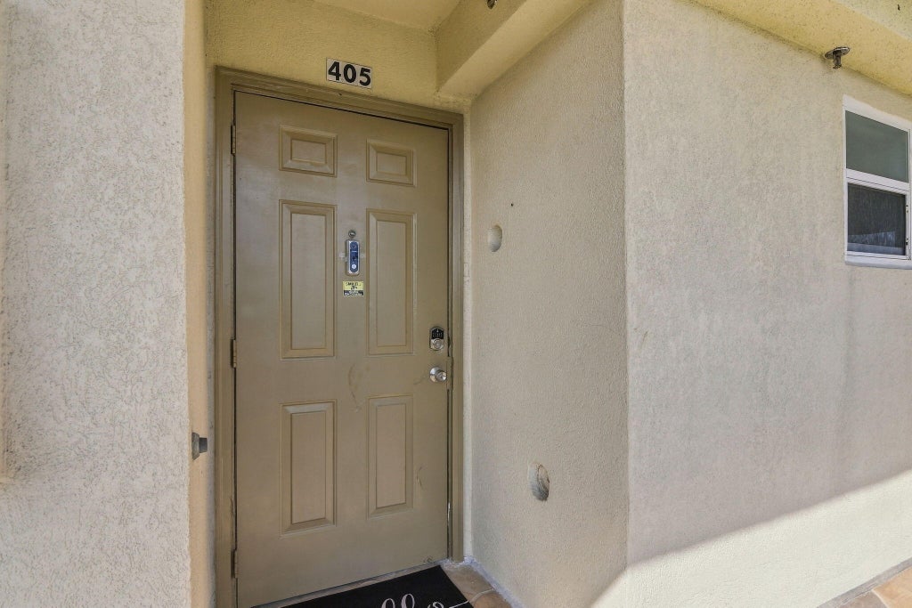 Photo of 3465 Via Poinciana #405, Lake Worth, FL 33467 (MLS # B26078412)