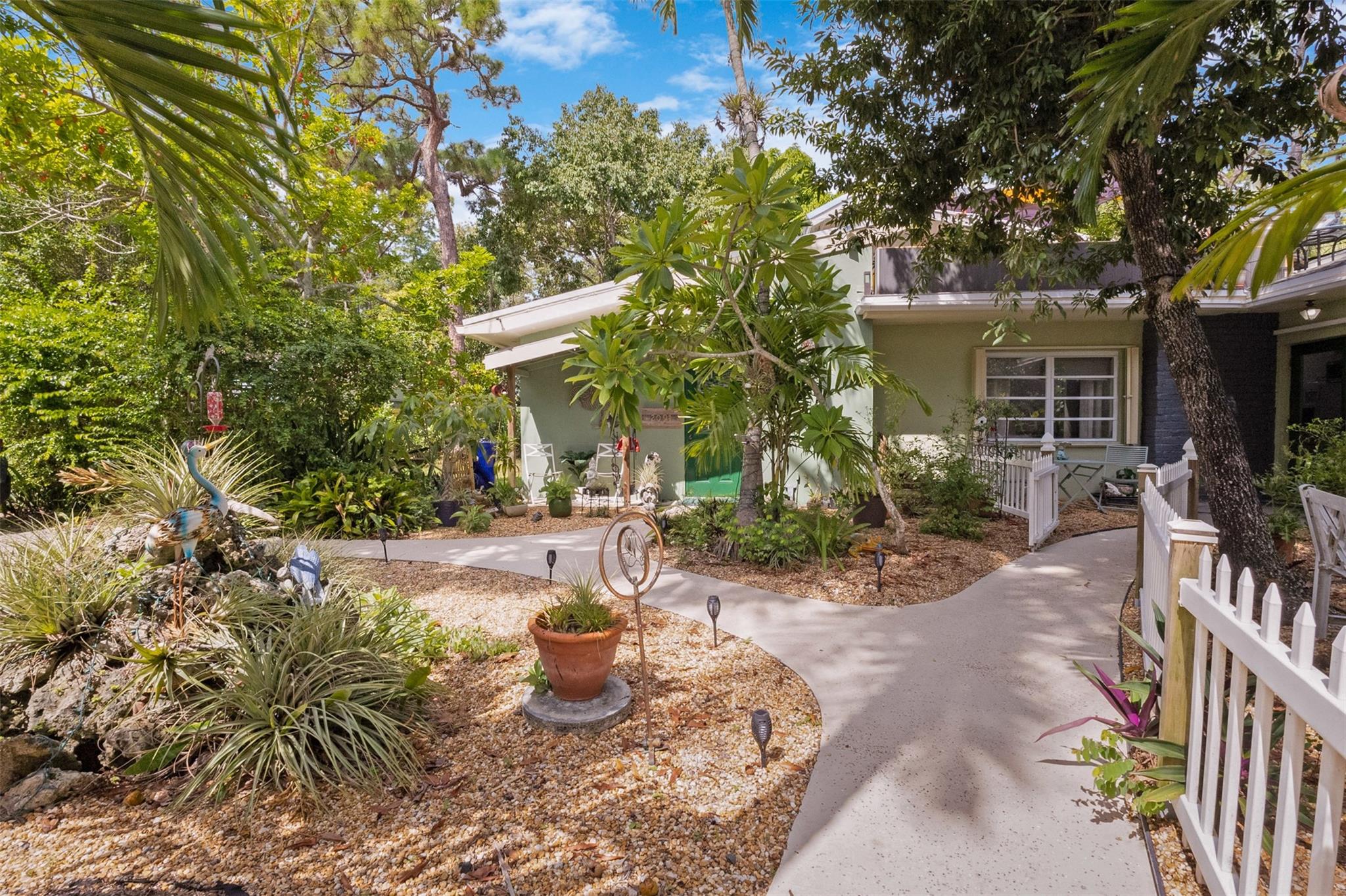 Endless Possibilities. Unique family home provides multiple living scenarios. Main residence has open remodeled white kitchen with countertops and back splash. Newer stainless steel appliances. Romantic fireplace. Island bar & countertop. Very high vaulted ceilings lead to large loft master bedroom with spacious closet remodeled master bedroom. Outdoor second story private patio off master. In-laws one bedroom suite (easily becomes 2 BDR) completely remodeled bath and kitchen. Large outdoor patio with seating. Rear Quarters has completely remodeled kitchen area& bathroom. Private screened patio & yard. Central Quarters has remodeled kitchen & bathrooms. Two Laundry's. Newer W/D. Use for large family living, investment or short/long terms rentals. Easily returned to SFR. NO HOA.