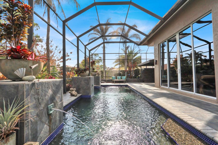 Welcome to an extraordinary residence in Cypress Point, one of the most sought-after neighborhoods within PGA Village--where luxury, privacy, and resort-style living come together in perfect harmony. A BACKYARD OASIS LIKE NO OTHER:  Step outside to your own private resort-style retreat. The breathtaking pool features a stunning pebble finish, glistening tile accents, elegant fountains, and a beautiful tile deck. A marble walkway meanders gracefully through lush, exotic tropical landscaping, creating a serene and secluded escape. With expansive covered patio areas, a screened lounging space, and an additional awning for extended shade, this outdoor oasis is designed for both entertaining and tranquil relaxation. Every inch reflects the owners' pride and meticulous attention to detail. Refined Interior Craftsmanship & Modern Design:

Inside, quality craftsmanship and distinctive style shine throughout this 3-bedroom + den, 2.5-bath home.

18" slate tile floors in the main living areas

Warm bamboo wood flooring in the bedrooms

Solid 6-panel wood doors and detailed wood trim

Floor-to-ceiling built-in bookshelves

A one-of-a-kind built-in glassware cabinet in the dining area with granite countertop and glass doors

The chef's kitchen is both beautiful and functional, featuring top-of-the-line Viking and Thermador appliances, rich wood cabinetry with abundant drawers, and gleaming granite countertops. The modern aesthetic continues throughout the home, complemented by upgraded bath fixtures and high-quality finishes that reflect thoughtful design at every turn.

Prime Location with Privacy:

Situated on a private corner lot backing to the golf course, this home offers exceptional privacy while remaining in the heart of the community--close to the gate and clubhouse, yet peacefully tucked away from I-95. A short ride brings you to the Island Club and all community amenities.

Residents of PGA Village enjoy access to the clubhouse featuring a resort-style pool, fitness center, tennis, pickleball, and a full calendar of social activities. Golf enthusiasts will appreciate three world-class PGA golf courses and The Legacy Golf & Tennis Club, a premier private club.

Just outside the gates, you'll find dining, shopping, the New York Mets spring training facility, and all essentials for daily living. Plus, you're only a short drive from some of Florida's most beautiful beaches.

Some furnishings are negotiable, making this exceptional property even more enticing.

This is more than a home--it's a lifestyle.