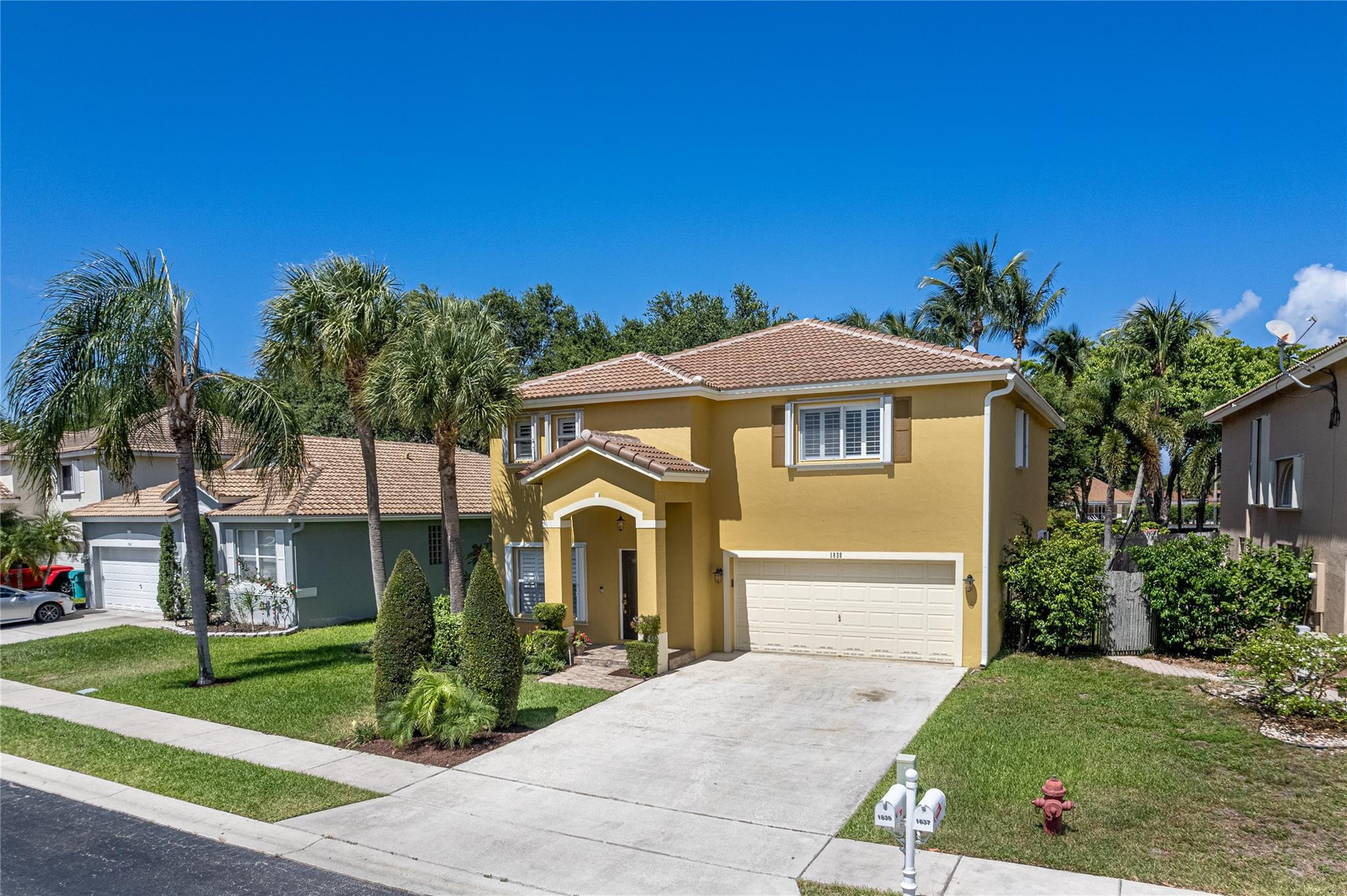 Here's your chance to step into a home where pride of ownership radiates from every corner! This beautifully updated 4/2.5 gem welcomes you with soaring 20-foot ceilings and an abundance of natural light that fills the main living area through the plantation shutters throughout. The expanded kitchen is a chef's delight, boasting ample storage and endless counter space, solid wood cabinetry, and stainless steel appliances. Upstairs features hardwood floors and the primary bedroom boasts a stunning NEW MASTER BATH, featuring a luxurious standalone tub and an oversized shower. Enjoy ultimate peace of mind with a BRAND NEW ROOF and Full HURRICANE PROTECTION on all openings. This meticulously maintained home, cherished by its original owner, truly feels loved and ready for its next chapter.
