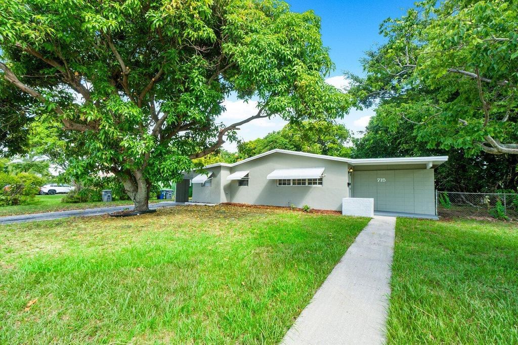 Photo of 715 W Jasmine Drive, Lake Park, FL 33403 (MLS # R11008064)